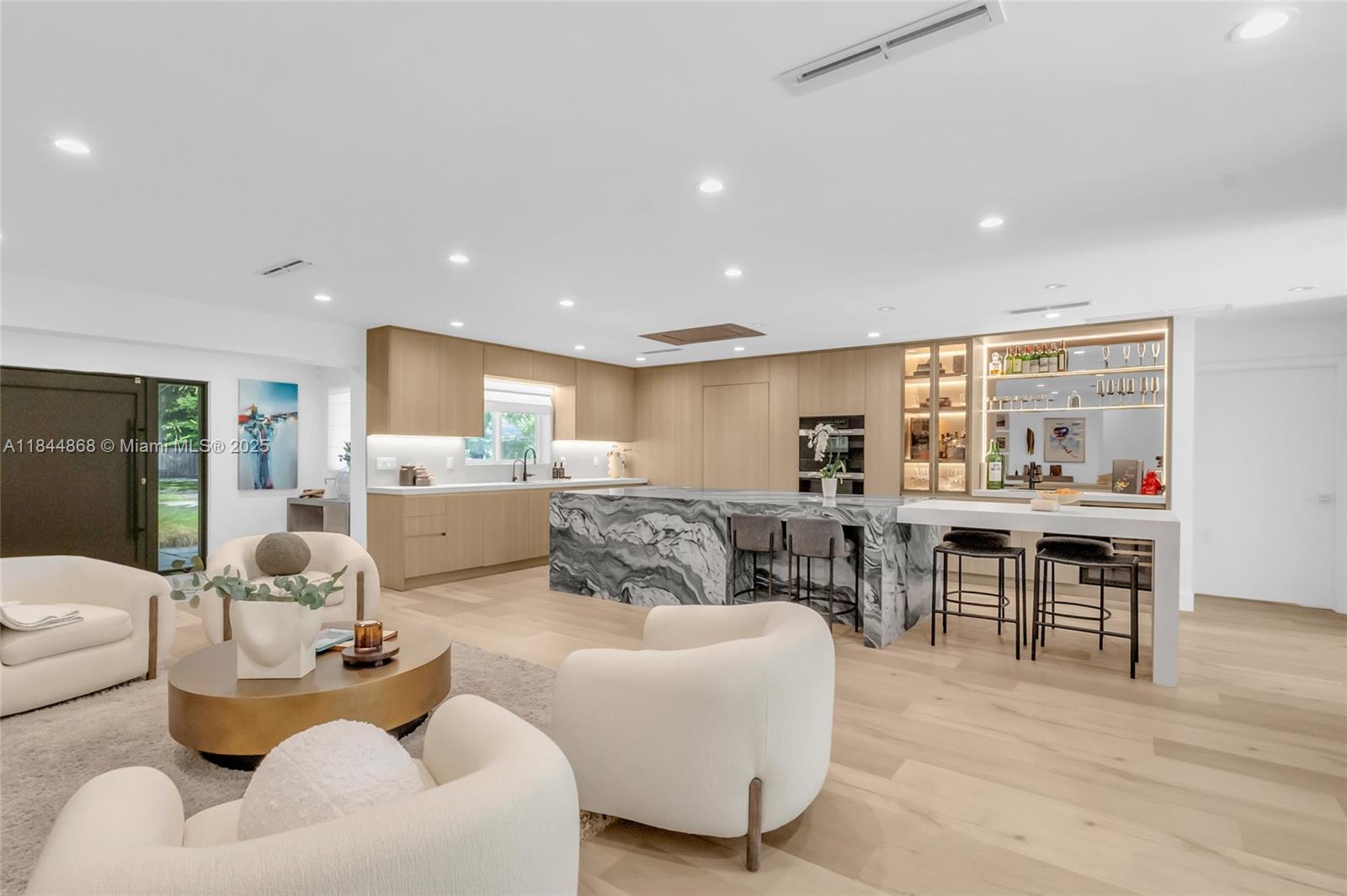Experience luxury living in this fully renovated and expanded 2023 Pinecrest home. Gutted and reimagined with modern design and high-end finishes, this turnkey gem features a chef’s kitchen with Miele appliances, hidden walk-in pantry, and built-in bar. The spa-inspired primary suite offers a private lounge, hidden office, and luxe bath. Two oversized en-suite bedrooms downstairs, plus two additional bedrooms, one used as a gym with sauna. Indoor laundry, heated pool, and sleek outdoor kitchen. New roof, impact windows, updated plumbing, HVAC, and designer details throughout. A rare Pinecrest find for buyers wanting a new construction feel without the wait.