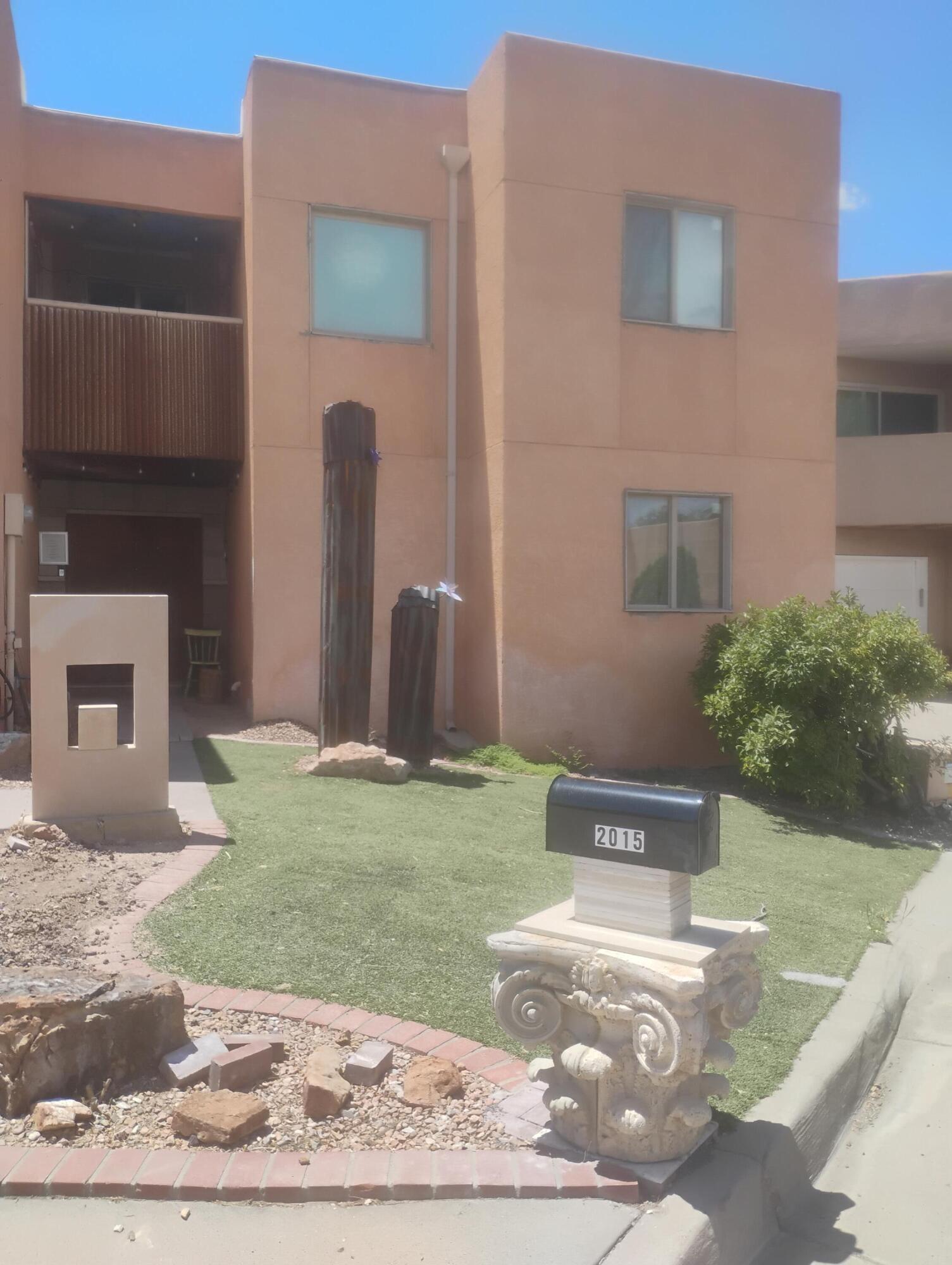 Adorable townhome conveniently located near UNM, Netherwood Park, fine dining and shopping including Whole Foods. Functional floorplan includes Great Room with raised ceiling, ceiling fan, and cozy rock FP with gas log lighter, dining area that opens to the covered backyard patio which is great for entertaining, full appliance kitchen with stone countertops, and 3 or 4 bedrooms including spacious upstairs primary suite with large walk-in closet, full bath, skylight, ceiling fan, and private balcony with awesome mountain views. A separate loft bedroom also located upstairs. Finished 2 car garage. Newer TPO roof. Refrigerated AC for improved comfort and private fenced backyard.