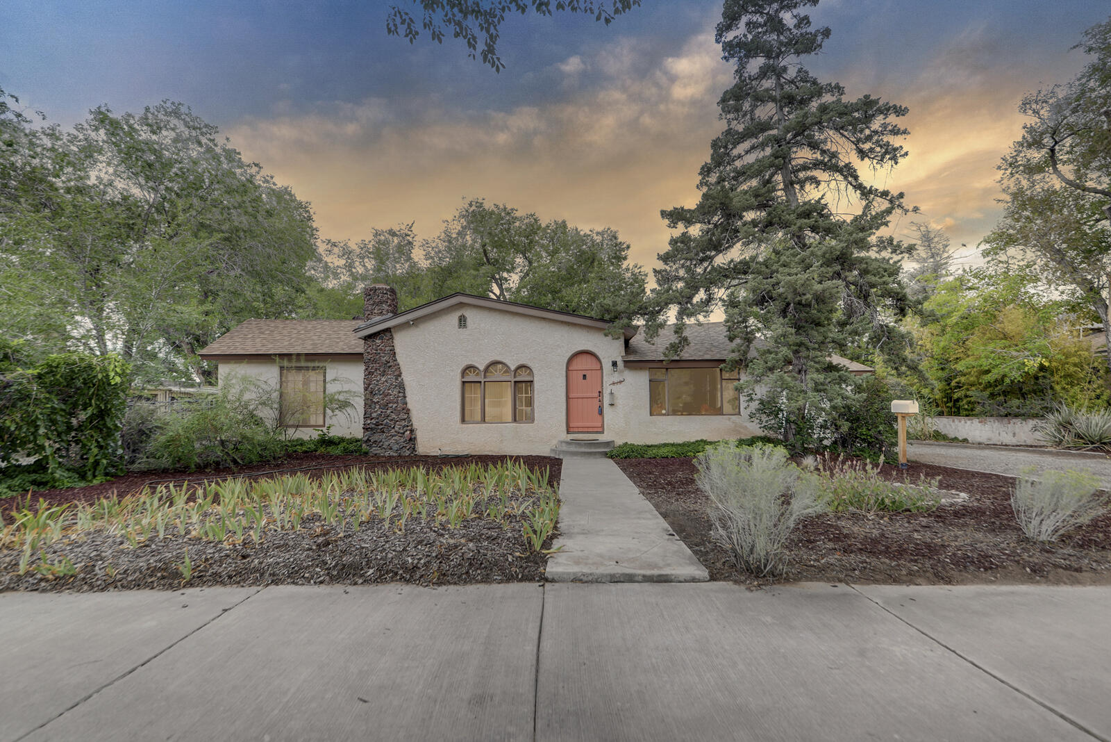 Lovingly Restored  (by  owner since 1995) Historic Nob Hill  Home on 1/4th  acre lot.  Character abounds. Arched windows and doors. Plaster walls. 9 foot coved ceilings. Beautiful hardwood floors in LR, DR, parlor,& all bedrooms. No carpet. Kiva fireplace and embossed plaster  in parlor. 2 primary bedrooms. Walk-in closets in all bedrms.  Remodeled back primary bathroom w/ tiled walk-in shower. Spacious Remodeled kitchen with quartz countertops, ample cabinetry and newer appliances.  House rewired with grounded outlets.  New Roof 2019. New furnace 2024.  2 water heaters. Over-sized attached 2 car garage. Extra wide deep driveway.  594 SQ FT basement (not included in the SQ FT).  Pizza oven in backyard + covered Ramada. Lush landscaping.  Your chance to own a piece of History!