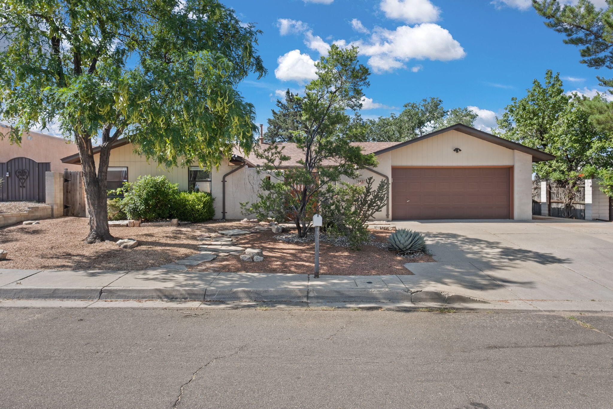 Welcome to your peaceful foothills retreat! Enter through a private courtyard with a security door into a light-filled home with skylights and a charming kiva fireplace for cozy evenings. The spacious kitchen comes fully equipped with all appliances, ready for gatherings. Enjoy newer refrigerated air and furnace, and roof all replaced (2019) for peace of mind. Three living areas!  Relax on the shady backyard deck or garden in the dedicated southeast corner. Recent upgrades include a new courtyard gate (2023) and a backyard retaining wall (2020/21). Walk to scenic Embudito and Copper trailheads, parks, top schools, and nearby dining, library, and Flix Brewhouse. Three driveway spaces and coated ductwork complete this comfortable, well-located gem.
