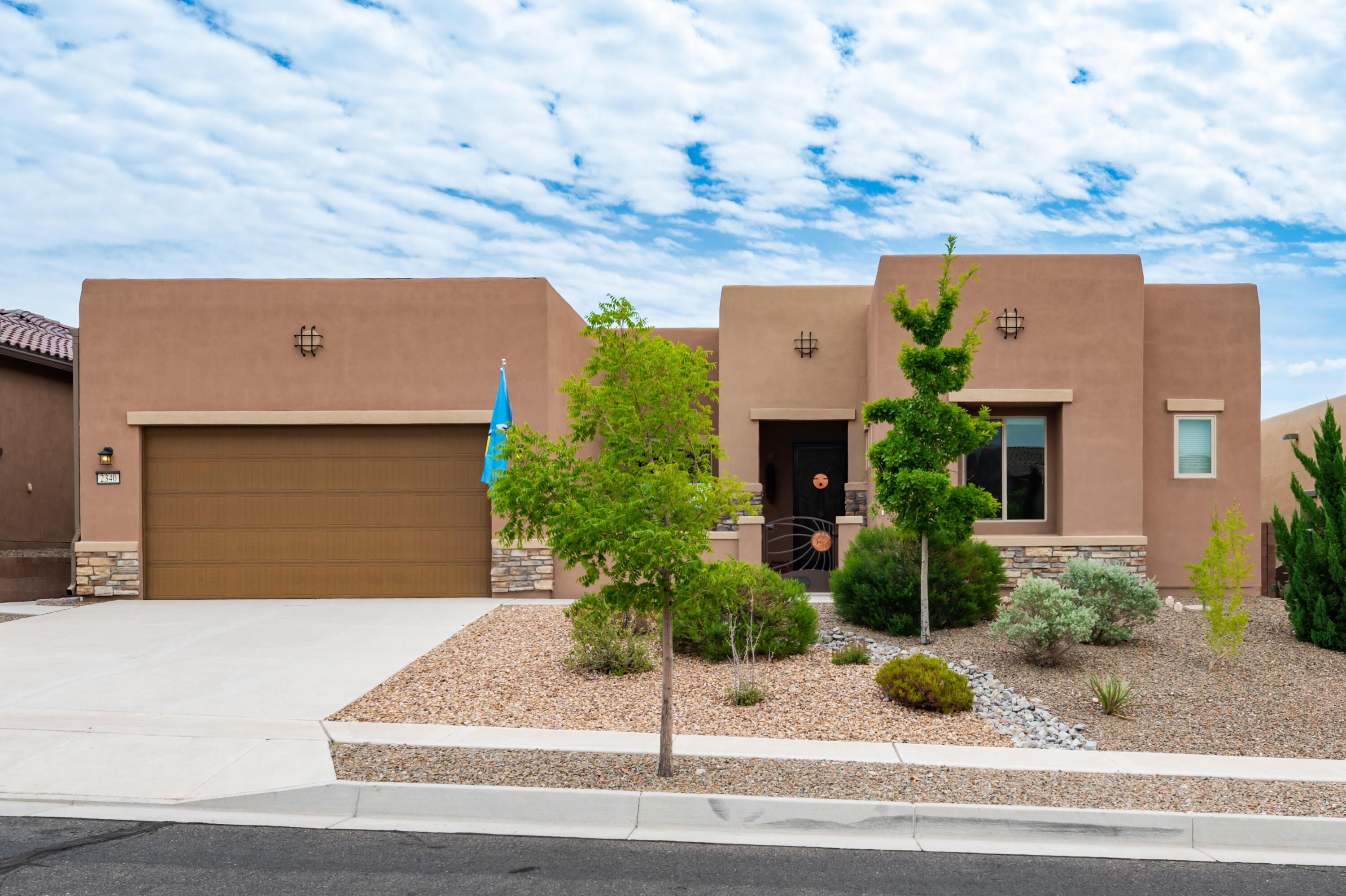 Wonderful Home Located on a View Lot adjacent to the Petroglyph National Monument in the 55+ Community of Del Webb Mirehaven!  Original Owners built this home as a 2nd home in 2018. You'll love the mountain and city views!  This Endeavor floorplan is a little over 2500 sf and has 2 Primary Suites plus an Office or Den, 2.5 Baths and there is storage space in the Garage.  Home has beautiful tile flooring throughout, Gorgeous Custom Front Storm Door, Courtyard and Side Gates, Gas Cooktop, Raised Dishwasher at the Kitchen Island, Bow Window at the Dining Room. You'll love the beautifully landscaped backyard and large covered patio! All Appliances Stay including the Washer & Dryer.  Enjoy daily activities at the Sandia Amenity Center which also has Pickle Ball, Tennis, Gym, Pool & much more!!
