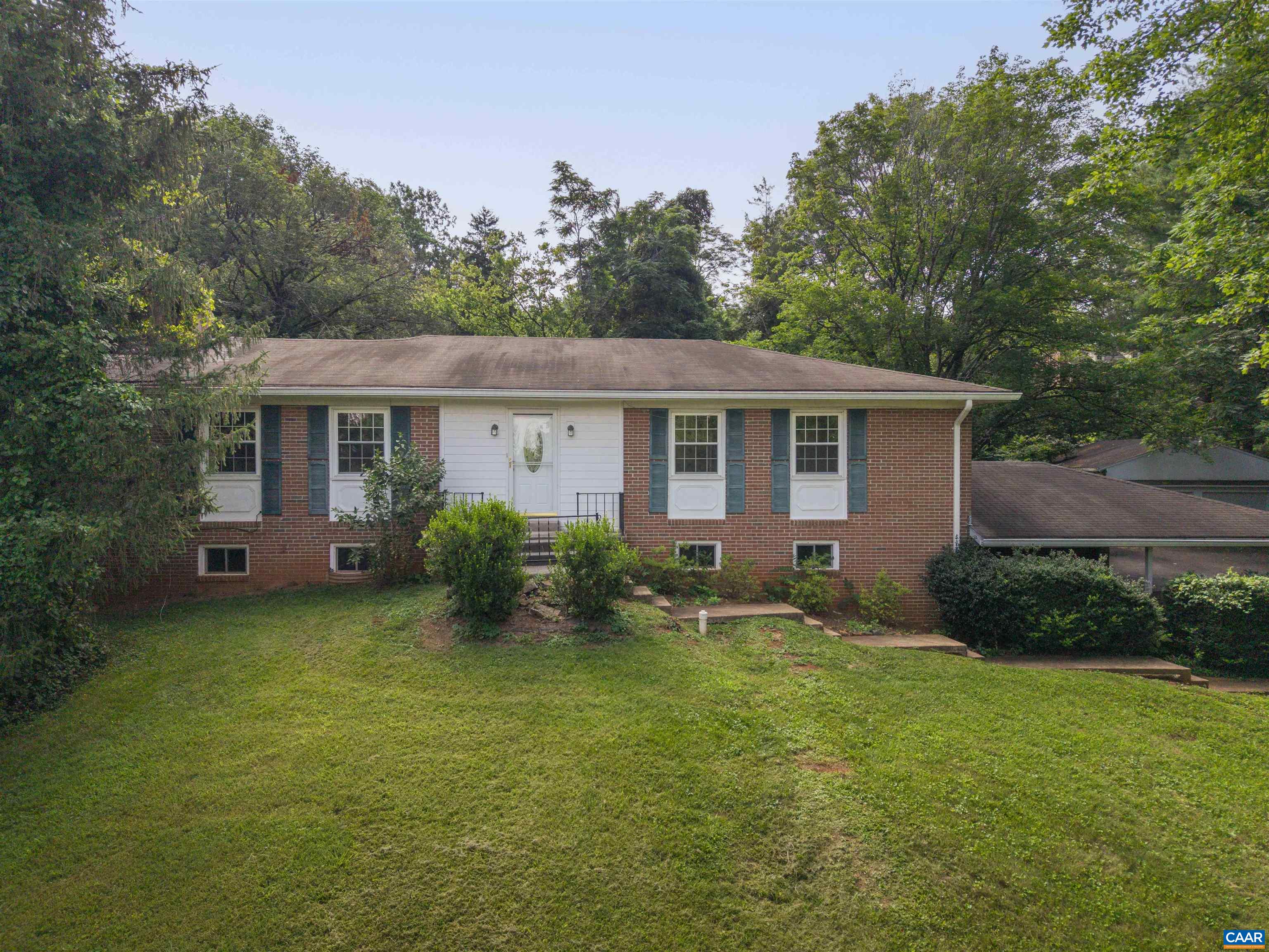 Well-built brick ranch house on two acres just minutes from town.  4-bedroom bedroom, 3- bath residence backs up to larger properties creating a rural setting less than 10 minutes to downtown Charlottesville.  No HOA.  Lower level has its own kitchen, sitting room, bed and bath.  Main level is 3 bed and 2 bath. Three season room takes advantage of the peaceful surrounding. 2-car detached garage and double carport.