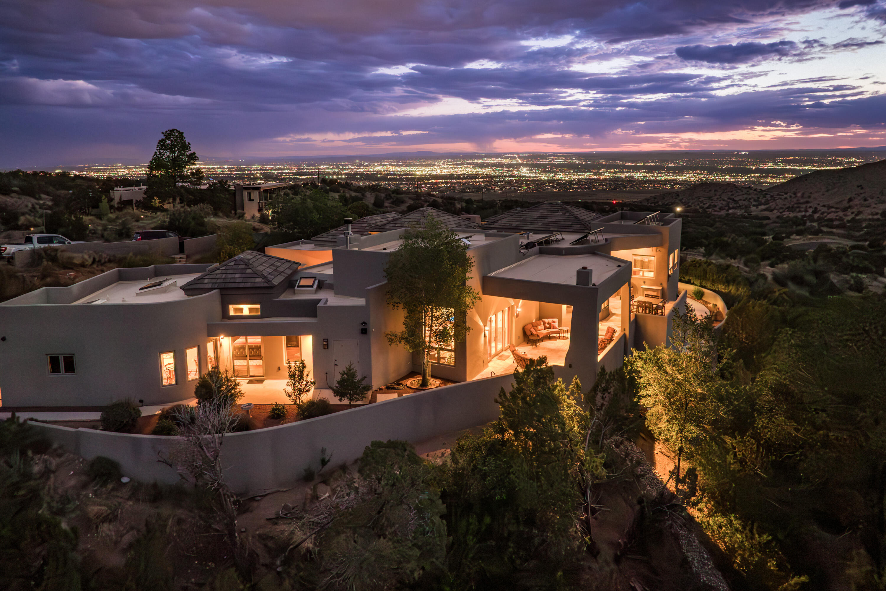 Awe Inspiring custom home bordered on the front by National Forest land w/ sunsets, city lights & monsoon storms rolling out before you endlessly.  Special. Designed in wings on either side of central living room & kitchen,this home offers privacy & exceptional opportunities to live, work, & thrive surrounded by nature.Large cook's kitchen w/tons of counter & cabinet space, granite,stainless appliances, gas stove, warming drawer & walk-in pantry.Living rm w/raised ceiling, fireplace, dual patio access & view. Primary on main flr includes frplc,sitting rm, spa like bath w/sauna/huge shower, soaking tub,& lrg walk-in.  Bath accesses patio w/hot tub to enjoy night skies. In-law suite w/living rm or game rm plus bed & bath. Many patios. Owned solar. Car charger. 1.19 AC . Geothermal heat/cool