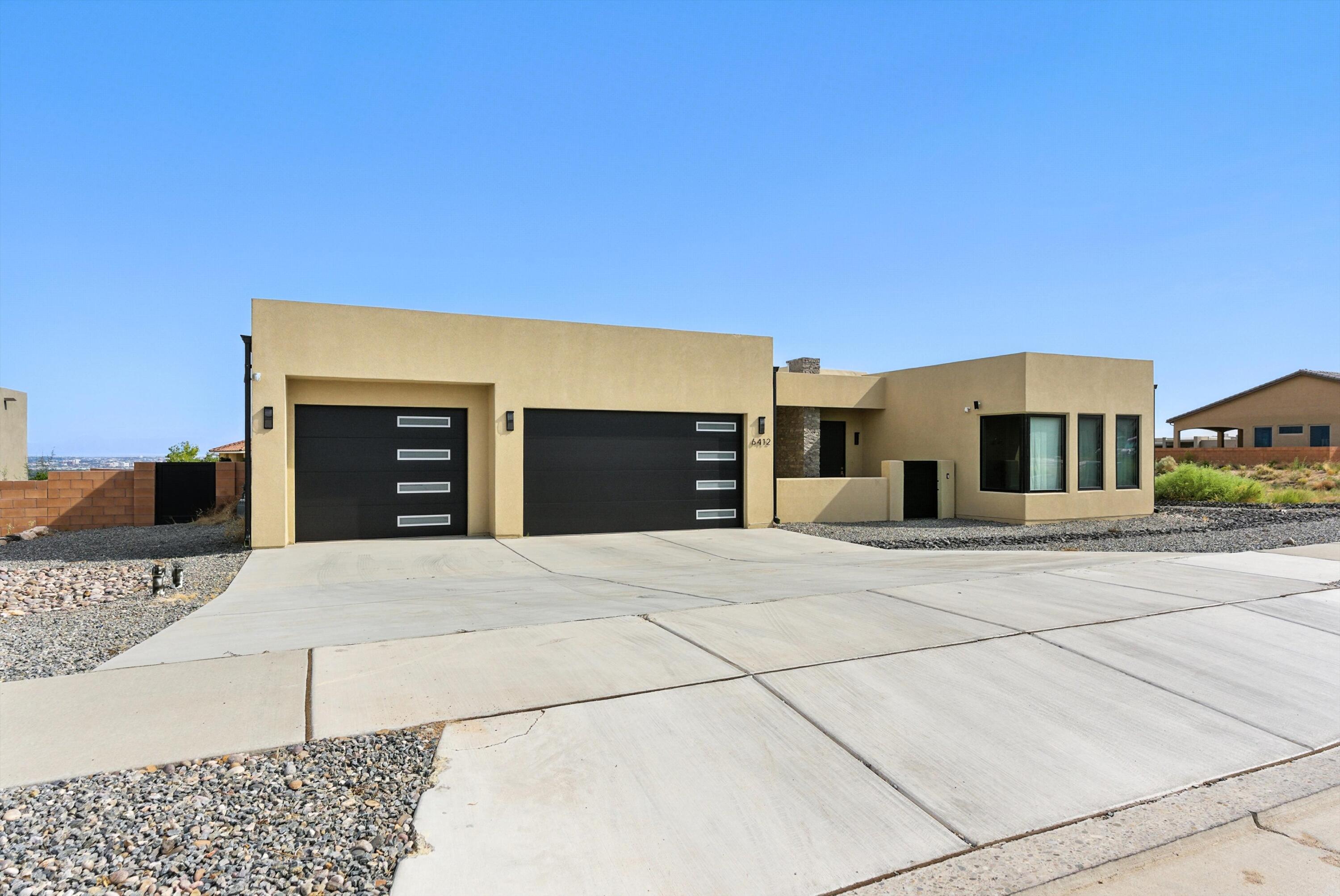 Welcome to this 3,360&#8239;sq&#8239;ft custom residence nestled in Volcano Cliffs. With three bedrooms and six bathrooms, this standout property is designed for contemporary upscale living, offering panoramic valley, city, bosque, and Sandia Mountain views. Inside, soaring ceilings and abundant natural light elevate the open floor plan. The chef-worthy kitchen opens to spacious living areas ideal for entertaining. Outside, enjoy over 900&#8239;sq&#8239;ft of outdoor living space, complete with a 4018 gunite pool, separate hot tub, and space for outdoor kitchen amenities. High-end systems include dual A/C and heating, tankless water heaters and a gas-ready outdoor kitchen. Constructed with energy-efficient 26 exterior walls and full insulation, the home offers modern performance and styl