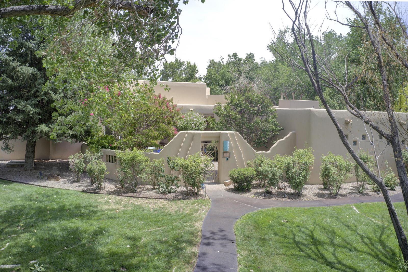 Welcome home to 5800 Tinnin rd. Nestled in the heart of the North Valley, this beautifully crafted Tinnin Farms custom home blends timeless Southwestern character in one of Albuquerques Most prestigious neighborhoods. This custom Adobe-style home offers classic Southwestern charm and solid craftsmanship throughout. From the moment you enter the private, welcoming courtyard, you'll be drawn into a warm, character-rich space featuring Vigas, Latilla ceilings, Santa Fe-style adobe accent walls, and two custom fireplaces.While much of the home remains in its original condition, it has been exceptionally maintained with upgrades that include:  A newer TPO roof, owned solar system, updated stucco, newer refrigerated air, and replaced skylights.The kitchen includes granite countertops,