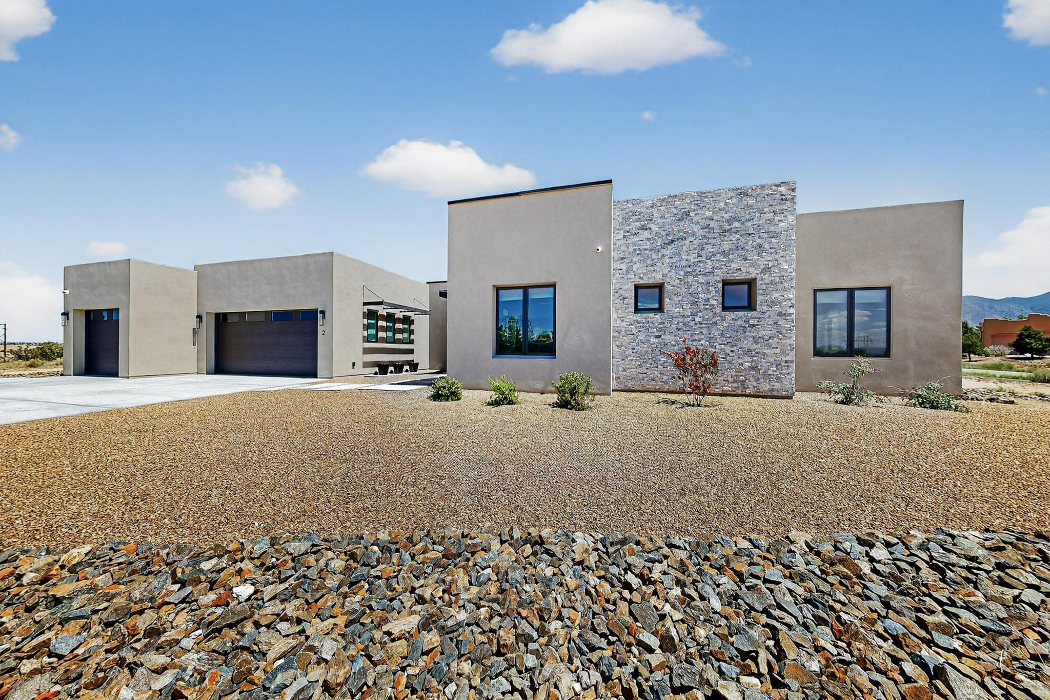 Welcome to the pinnacle of living, peace adn serenity, in the picturesque community of Placitas. Experience contemporary luxury and cutting-edge smart home technology in this open-concept home. This stunning residence boasts high ceilings and large windows that frame panoramic mountain and sunset views, inviting natural light to illuminate the Italian porcelain tile flooring. Enjoy the versatility of three spacious bedrooms plus an office, alongside a well-equipped exercise room. The heart of this home features walnut custom cabinets, granite counters, under cabinet LED lighting and a generous walk-in pantry with a coffee bar for your culinary adventures. Primary suite has separate entry to the patio, expansive views, generous walk-in shower and freestanding tub. The outdoor