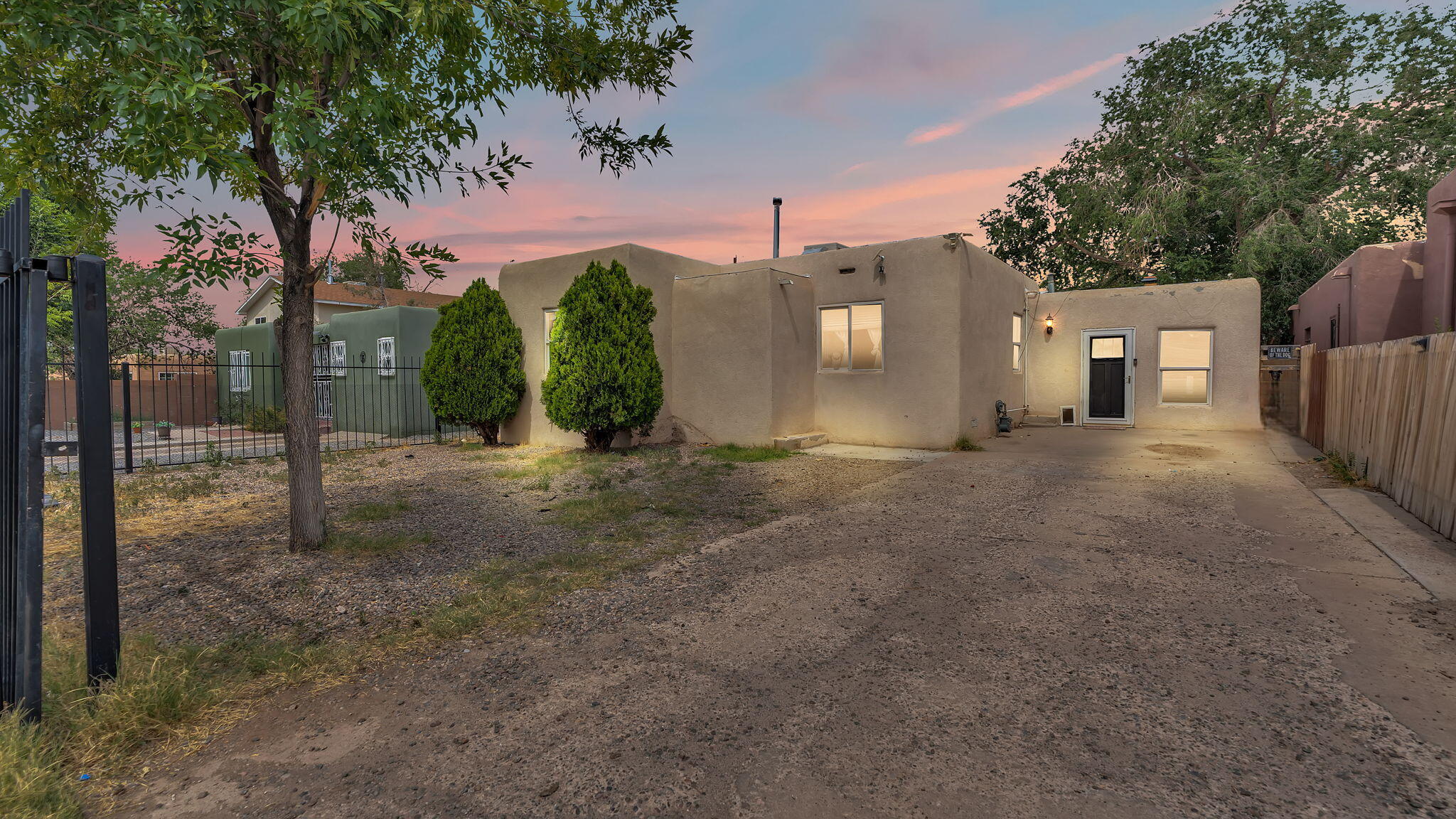 Charming 4-bedroom, 2-bath home with a functional layout and great potential in a central Albuquerque location. Features include a cozy living area, dedicated dining space, and a practical kitchen with ample cabinet storage. Bedrooms offer flexibility for guests, office, or hobby space. Stucco exterior, flat roof, gated front yard, and off-street parking provide added convenience and privacy. Mature trees add shade, and the backyard offers room to garden, play, or expand your outdoor living. Convenient indoor laundry area adds to the home's practicality. Close to schools, shopping, dining, and major roadways--ideal for first-time buyers or investors looking to build equity and personalize a space of their own. Schedule your showing today!