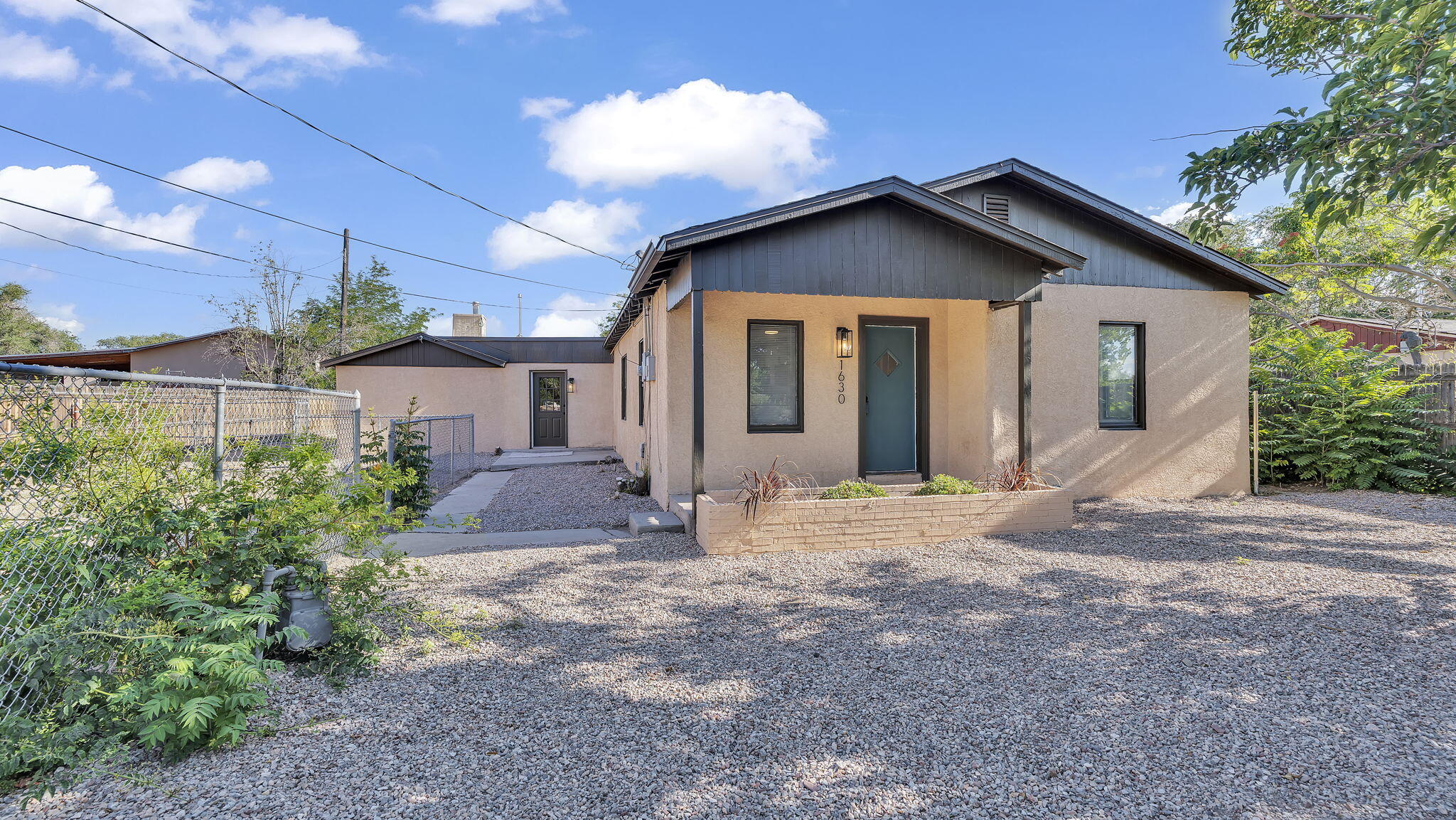South Valley Stunner!! Step into comfort and versatility with this beautifully updated 4-bedroom, 2-bath home in the heart of the South Valley. Offering 2,554 sqft of living space on nearly half an acre, this spacious property offers backyard access--perfect for extra parking, recreational vehicles, or your favorite outdoor hobbies. The spacious layout features a large family room, cozy wood-burning fireplace, and fresh updates throughout. A private mother-in-law quarters adds flexibility for guests or multi-generational living. Need space to create or store? The detached garage/workshop is ready to meet your needs. Located minutes from shopping, dining, and freeway access.