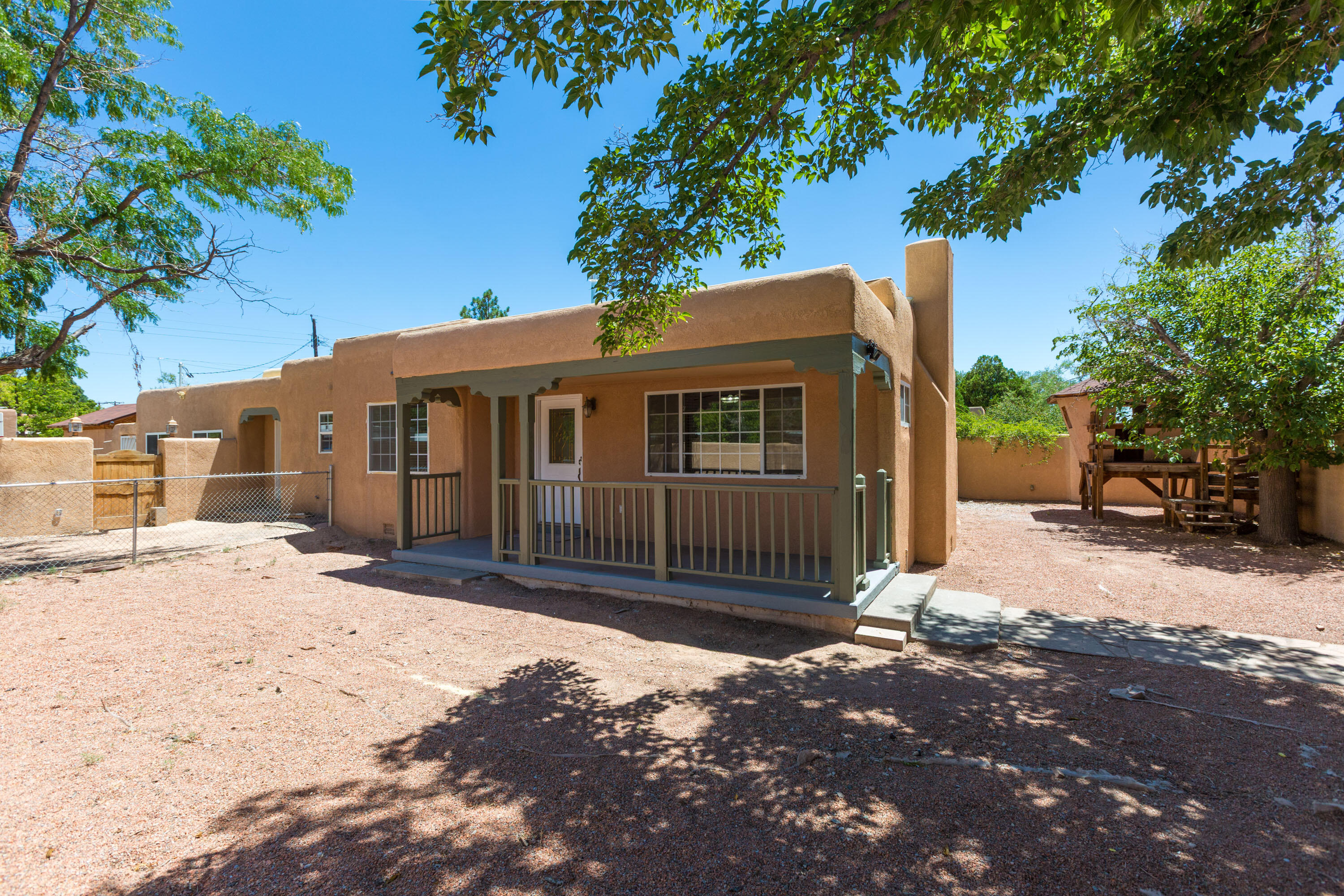 PRICE REDUCED $20,000!!  Dont miss this gem. Ready for immediate move-in! Terrific UNM home with new TPO Roof with 20 yr warranty plus brand new LVT flooring in all living areas with brand new carpet in each of the 3 bedrooms .  New paint, new gas stove - ready for immediate move-in.  Updated baths and much more.  Lots of beautiful kitchen cabinets; separate laundry room; large primary 3/4 bath with walk-in closet. Updated hall bath with tub/shower combo.  Lots of outdoor space for gardening or whatever you need space for. Stucco courtyard wall provides lots of privacy for this wonderful home.  Family room has separate entrance and can be used as home office.  Don't miss this one!  It's definitely a gem!!