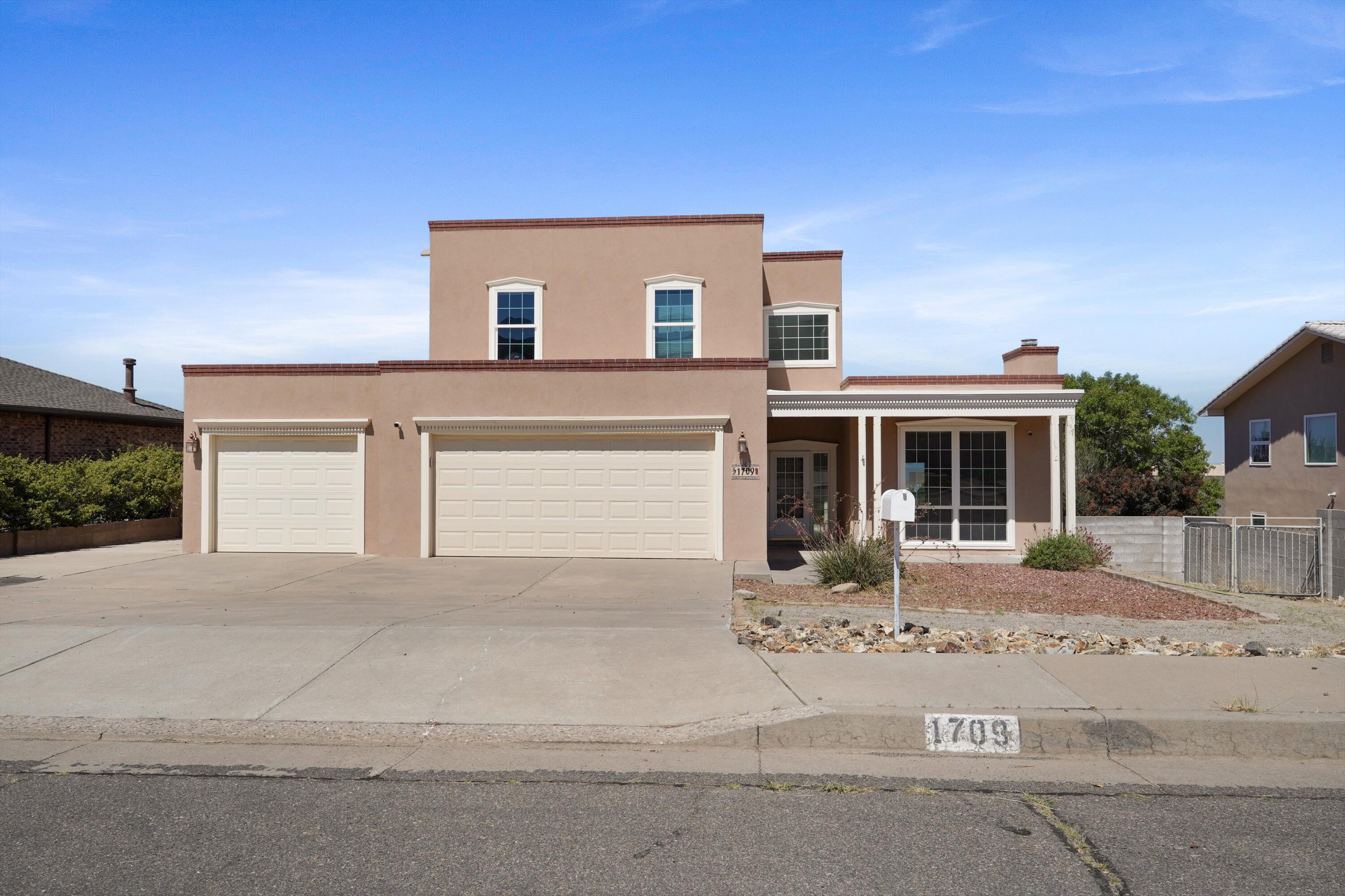 Welcome to this stunning custom-built territorial-style home, perfectly situated in the heart of Albuquerque at the base of the Sandia Mountains. Enjoy breathtaking mountain views from this beautifully designed 3-bedroom, 3-bathroom residence, offering 2,253 square feet of timeless Southwestern charm blended seamlessly with modern comforts. Step inside to discover brand-new carpet (2025) that complements the bright, open layout bathed in natural light. The living areas are warm and inviting, flowing effortlessly into an open-concept kitchen -- ideal for entertaining guests or enjoying a cozy night in. Recent upgrades include a brand new furnace and water heater (2024) for year round efficiency and comfort. Plus, owned solar panels for energy efficient living & long-term savings.