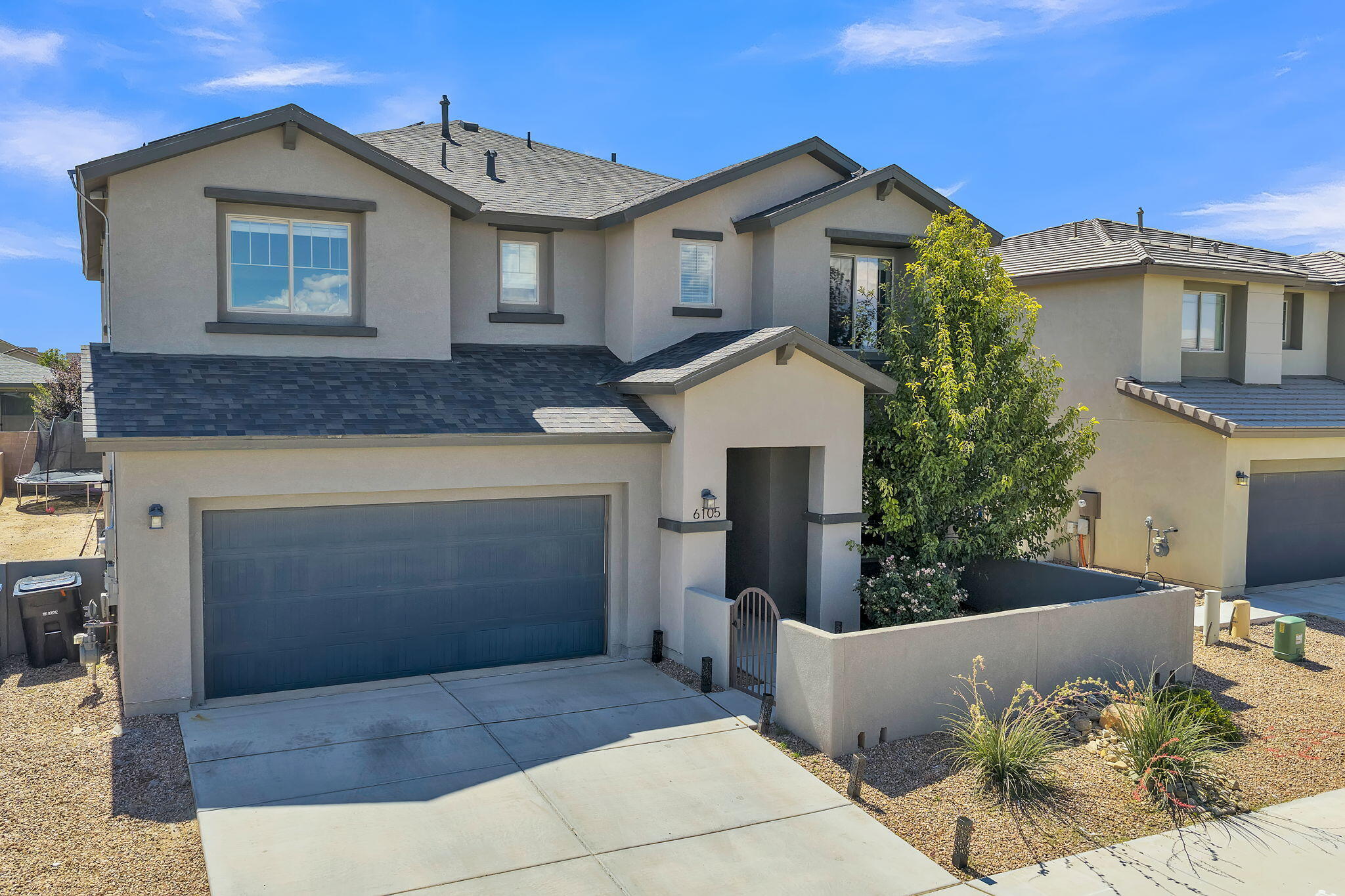 Located in the forward-thinking community of Mesa del Sol, this modern Pulte home blends comfort, technology, and sustainability. It is fully equipped with smart features throughout, including a smart thermostat, oven, water heater (with direct master override), water softener, garage door opener, door locks, and Ring security system. Enjoy no electricity costs thanks to a Tesla solar system (paid off at closing) sized to meet all your electricity needs, backed by a 25-year transferable warranty. Outside, a covered patio with an outdoor fireplace and landscaped yard provides the perfect space to relax or entertain. Mesa del Sol offers walking trails, parks, a grocery store, a gym, a community pool, and a PreK-12 school--all minutes from Netflix Studios, Kirtland AFB, I-25, and the airport.