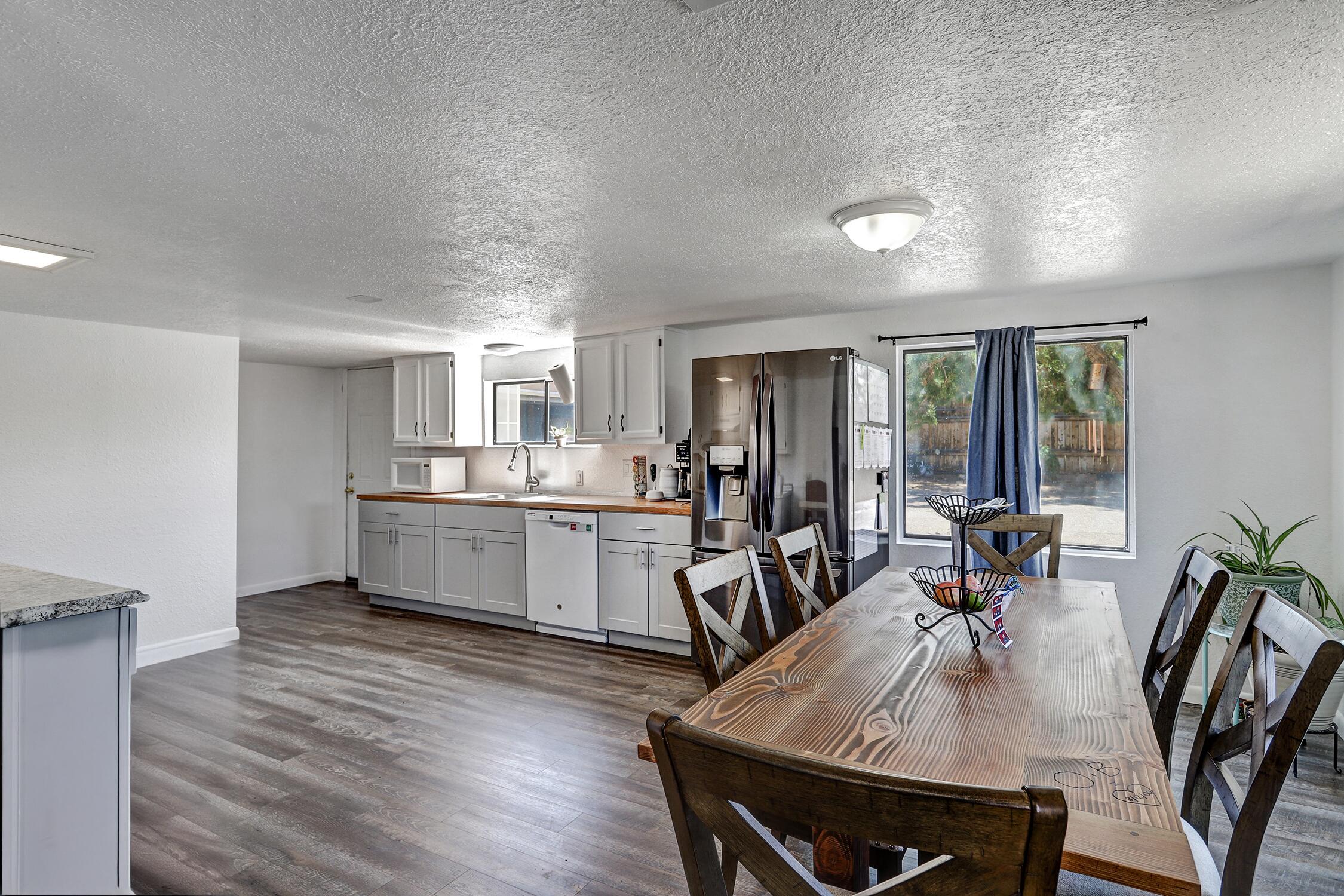 Finally, a home that keeps up with your ambitions. Spread out across 7 beds/primary on main, this versatile layout flexes for studios, guest space, home offices, & creative zones. The updated kitchen brings modern charm to everyday cooking, while gorgeous wood ceilings, fresh paint, and newer laminate flooring throughout pull the whole vibe together.You'll swoon over the 3-car garage/workshop w/ 220V power, room for tools, toys, or your weekend build. Multiple storage sheds keep everything organized, and ~1/2-acre lot is a blank canvas for raised beds, a future courtyard, or that epic backyard. Solar is owned and the home is pre-wired for mini-splits. Set on a low-traffic street, this property blends function with possibility.