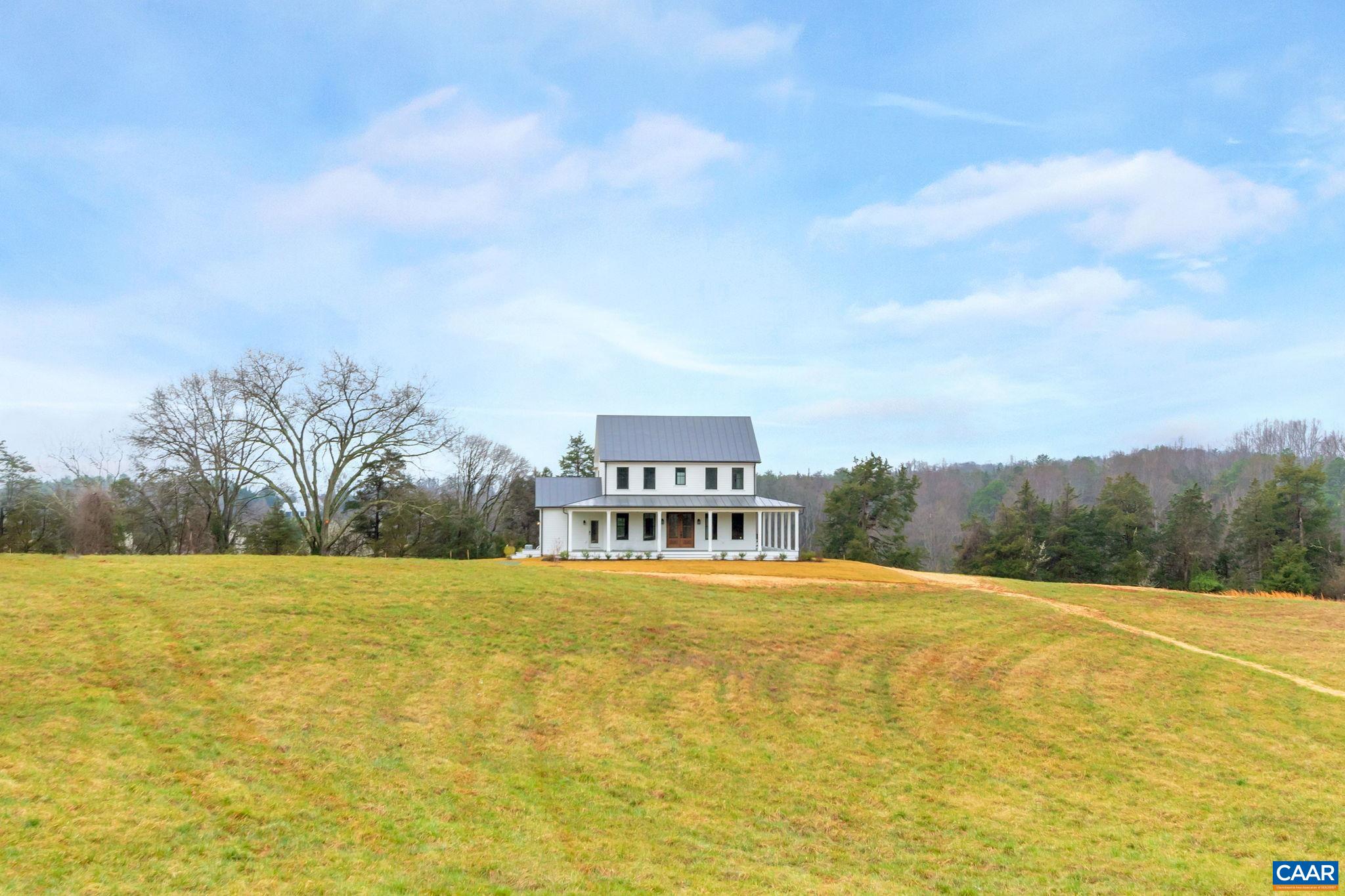 A classic 4 BR Virginia farmhouse TO BE BUILT on 76.99 acres with pastoral views, gently rolling fields and privacy-enhancing hardwood forests – surrounded by Southern Albemarle’s top equestrian farms & estates in conservation easement. Under 25 mins to UVA and downtown Cville. Located along a scenic, paved country road lined with mature hardwoods and classic black board fencing, the property is comprised of two parcels. The first is a 54-acre tract featuring approx. 34 acres of gently rolling open fields with a wooded core. The second is a 22-acre parcel of mature hardwood forest. This property's natural beauty and privacy offer the perfect setting for a family compound. With extensive road frontage, there's flexibility for multiple access points—ideal for a main residence, guest cottage, barn apt, or addl farm structures. The primary building site is gently elevated and tucked behind a grove of mature oak trees, offering the potential for a shaded lawn with sweeping panoramic views. A second site, accessible via graveled Glendower Rd, is a picturesque 9-acre cottage or barn location. Less than 10 mins to James River public boat launch. A wonderful country property that makes it easy to extend the weekend or work from home.