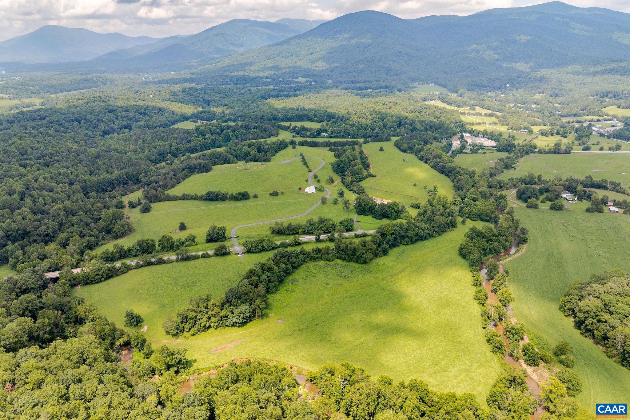 Lucky Dog Farm offers an extraordinary opportunity in the heart of Nelson County—ideal for a vineyard, estate retreat, or agritourism destination. Encompassing 121 scenic acres with panoramic mountain views, this remarkable property features a beautifully renovated century-old farmhouse, charming guest cottage, classic barn, river frontage, and three separate gated access points. A rare blend of history, beauty, and potential in one of Virginia’s most sought-after rural settings. Rendering of possible future vineyard included in the property photos.