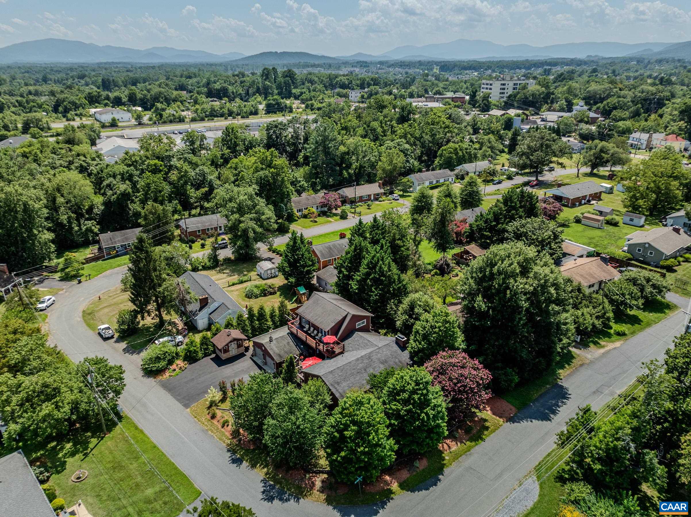 This home is a hidden gem in the heart of Crozet! Luxurious, private outdoor living spaces, upgraded kitchen and spa-like primary bathroom make this a must-see home walkable to Downtown Crozet shops and restaurants.  You'll love the solid hardwood flooring with cherry finish throughout the home. The formal living room features a grand floor-to ceiling stone fireplace as a focal point, and also includes a separate media area. The gourmet kitchen features granite counters, custom cabinetry, a striking copper double bowl sink, stainless appliances and a generous island with a built-in grill. The kitchen opens to a spacious dining room that is great for entertaining. The main level features three additional bedrooms and a full bathroom. The second floor features a secluded primary suite with two spacious walk-in closets, and ensuite bathroom boasting a freestanding soaking tub and stunning walk-in shower. Enjoy a morning cup of coffee on the private roof-top deck. The outdoor living spaces at this home stun with over 1500 sqft of private patios and decks!  With an unfinished basement, storage shed/workshop,  and two car detached garage this home is truly a gem! Current owners have rented as AirBnB. Ask agent for details.