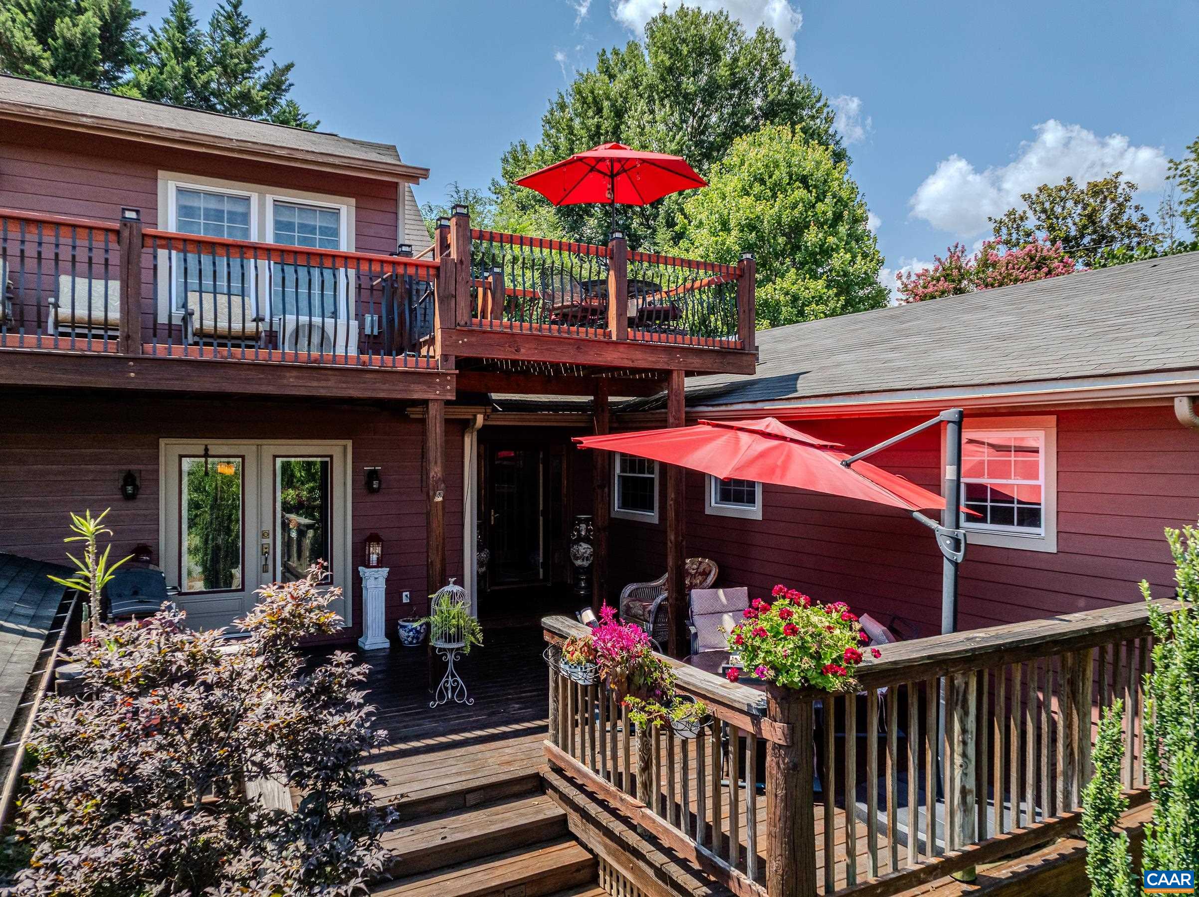 OPEN 10/26 2-4pm. Luxurious, private outdoor living spaces, upgraded kitchen and spa-like primary bathroom make this a must-see home walkable to Downtown Crozet shops and restaurants.  You'll love the solid hardwood flooring with cherry finish throughout the home. The formal living room features a grand floor-to ceiling stone fireplace as a focal point, and also includes a separate media area. The gourmet kitchen features granite counters, custom cabinetry, a striking copper double bowl sink, stainless appliances and a generous island with a built-in grill. The kitchen opens to a spacious dining room that is great for entertaining. The main level features three additional bedrooms and a full bathroom. The second floor features a secluded primary suite with two spacious walk-in closets, and ensuite bathroom boasting a freestanding soaking tub and stunning walk-in shower. Enjoy a morning cup of coffee on the private roof-top deck. The outdoor living spaces at this home stun with over 1500 sqft of private patios and decks!  With an unfinished basement, storage shed/workshop,  and two car detached garage this home is truly a gem! Current owners have rented as AirBnB. Ask Agent for details.