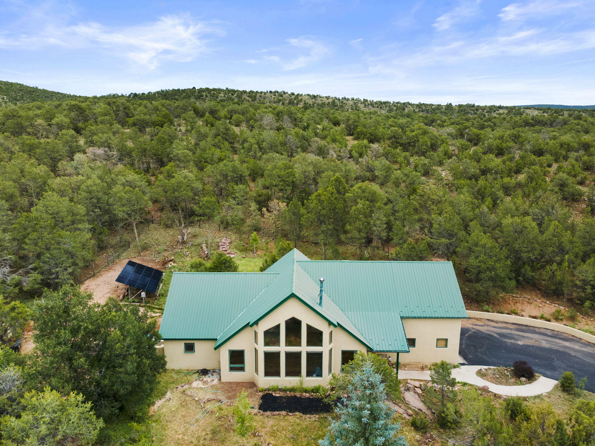 Absolutely amazing custom mountain   home located in the prestigious gated community of Eagle Crest Estates less than 10 miles to Albuquerque sitting on 2.12  acres w/pinion & juniper trees plus unobstructed mountain views of the Cibola National Forest. Recent updates all within a year  include new(never used septic) new(9 months ) owned solar and  Hearthstone wood stove ,  granite in kitchen and MBA, custom tile in primary shower, asphalt driveway with parking and recessed LED lighting!   Floor to ceiling Pella windows  in the great room allow stunning mountain views and plenty of natural light!    A huge butcherblock wet bar with glass upper cabinets spans the back wall of the great room .  Perfect for when you entertain or just a quiet glass of wine enjoying the view! Schedule now!