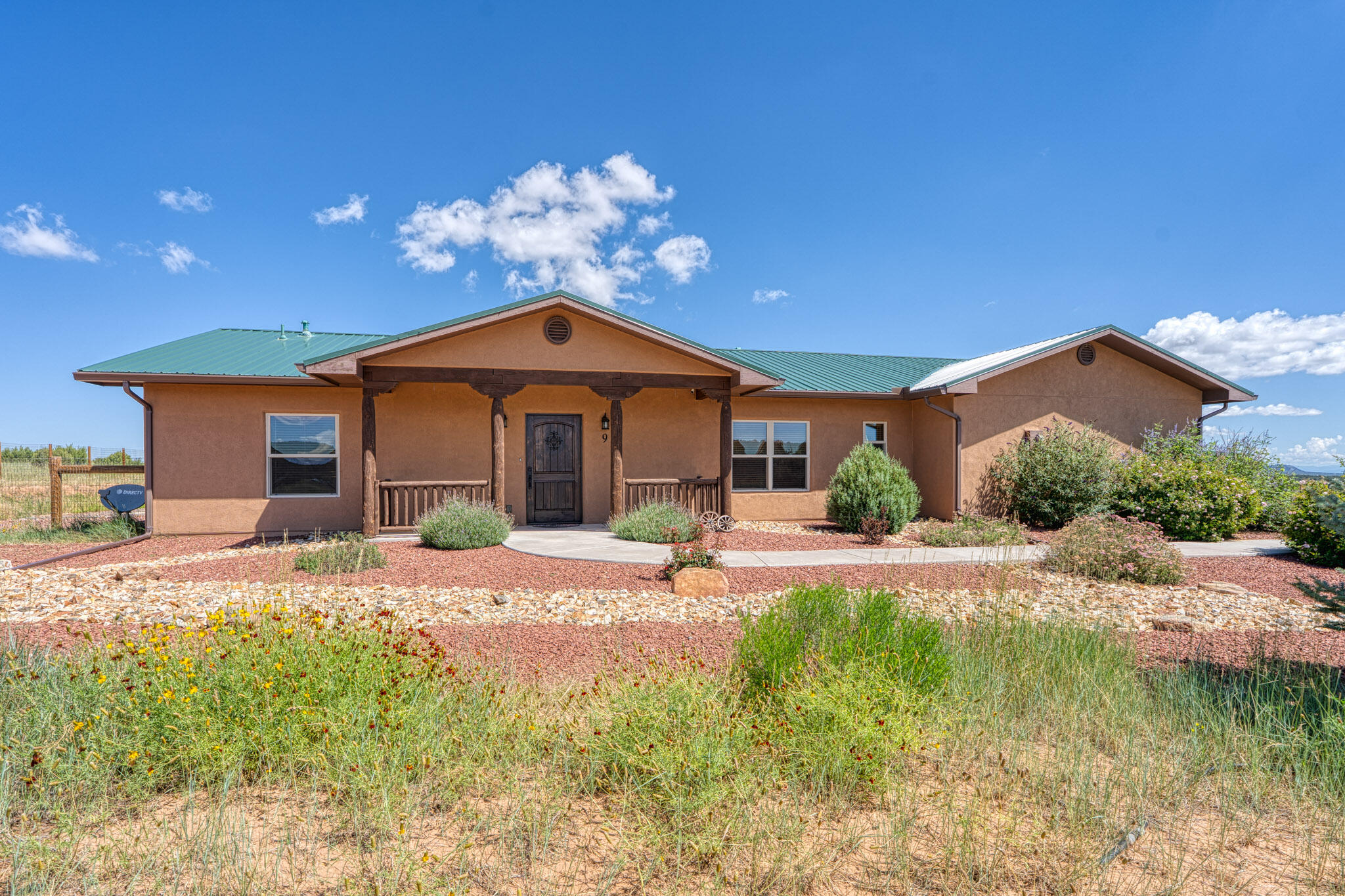 Peaceful east mountain escape in the desirable Las Leyendas community awaits your arrival! Vistas of the Sandias, Monte Largos and South Mountain frame the expansive patio views, while lovely landscaping blends with natural meadow to greet you upon arrival. Single story with open floorplan allows for formal dining in addition to a breakfast nook AND island seating. Spacious kitchen is the heart of the home, with primary suite tucked on one side of the home, while the secondary bedrooms and bath are neatly separated on the opposite side of the main living area.  HUGE pantry and more storage than most homes! Stunning T&G ceilings crown the living room, which is outfitted with a stacked-stone wood-burning fireplace...so cozy!