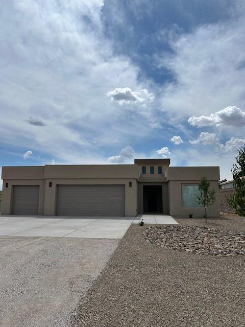 Absolutely beautiful custom-built home located on a spacious half-acre lot in the highly desired heart of Rio Rancho! This new construction features an open floor plan loaded with upgrades throughout. The flexible three or four-bedroom layout includes a split plan offering a private owner's suite separated from the guest bedrooms. The fourth bedroom can be used as an office, nursery, or additional bedroom to fit your needs.Enjoy two full bathrooms and one powder bath, all with elegant granite countertops.  12-foot ceilings in the living room, kitchen, and dining areas create an open and inviting space perfect for entertaining. The kitchen features abundant cabinetry, generous counter space, a walk-in pantry, a large center island, upgraded appliances, and beautiful granite countertops.