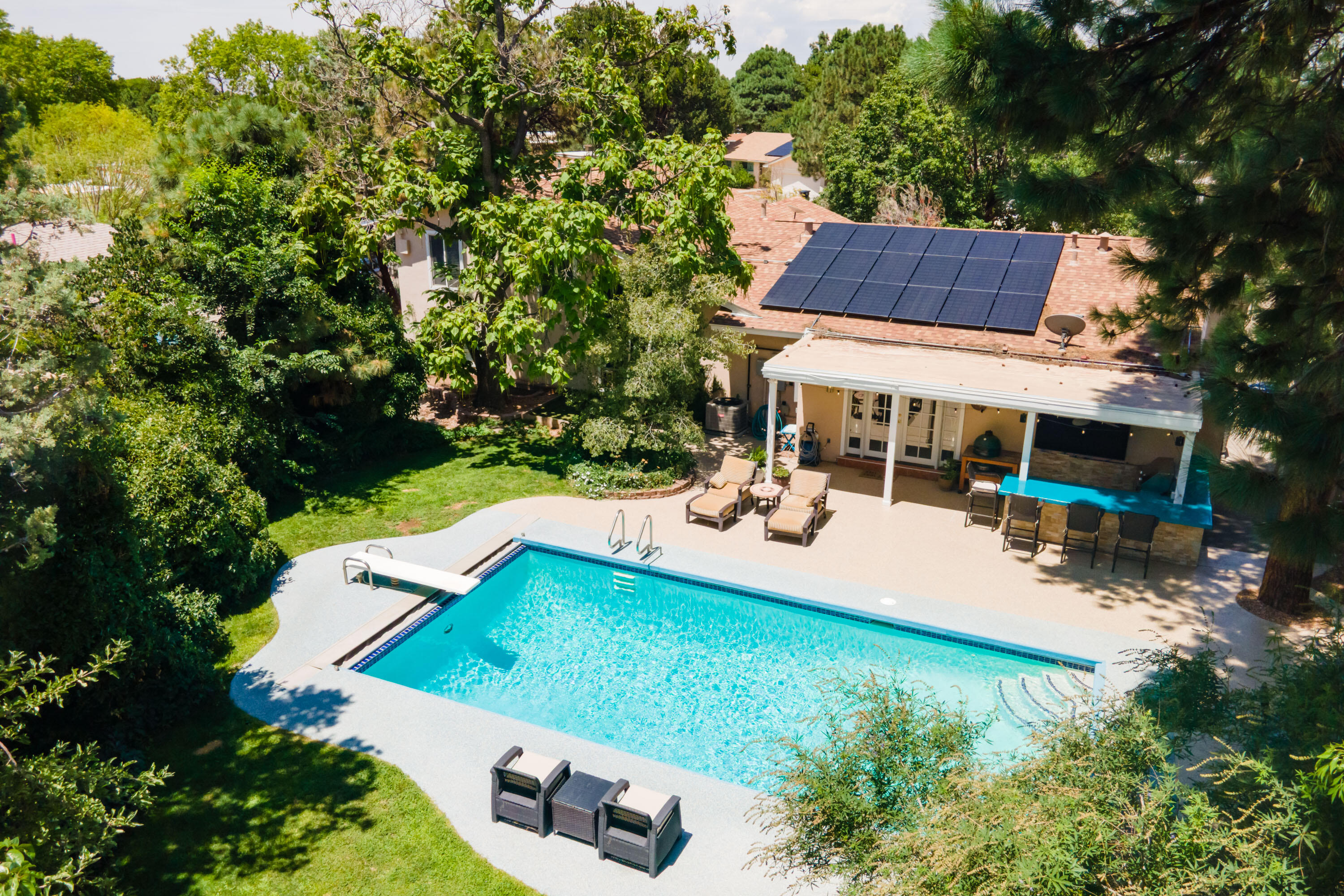 Stunning Mossman home nestled on over 1/3 of an acre on a corner lot. The backyard is a true oasis--featuring an in-ground pool, hot tub, outdoor kitchen, water feature, fruit trees, and a spacious covered patio. Inside, you'll find 3 bedrooms conveniently located downstairs, with a luxurious upstairs primary suite with custom California Closets. The open-concept kitchen flows into the living and dining area, complemented by a wet bar and French doors to the backyard. This home also offers a 2-car garage, 2-car carport, owned solar, a fast EV charger, and recent state of the art updates to all major mechanical. Located near a golf course, shopping, and schools.