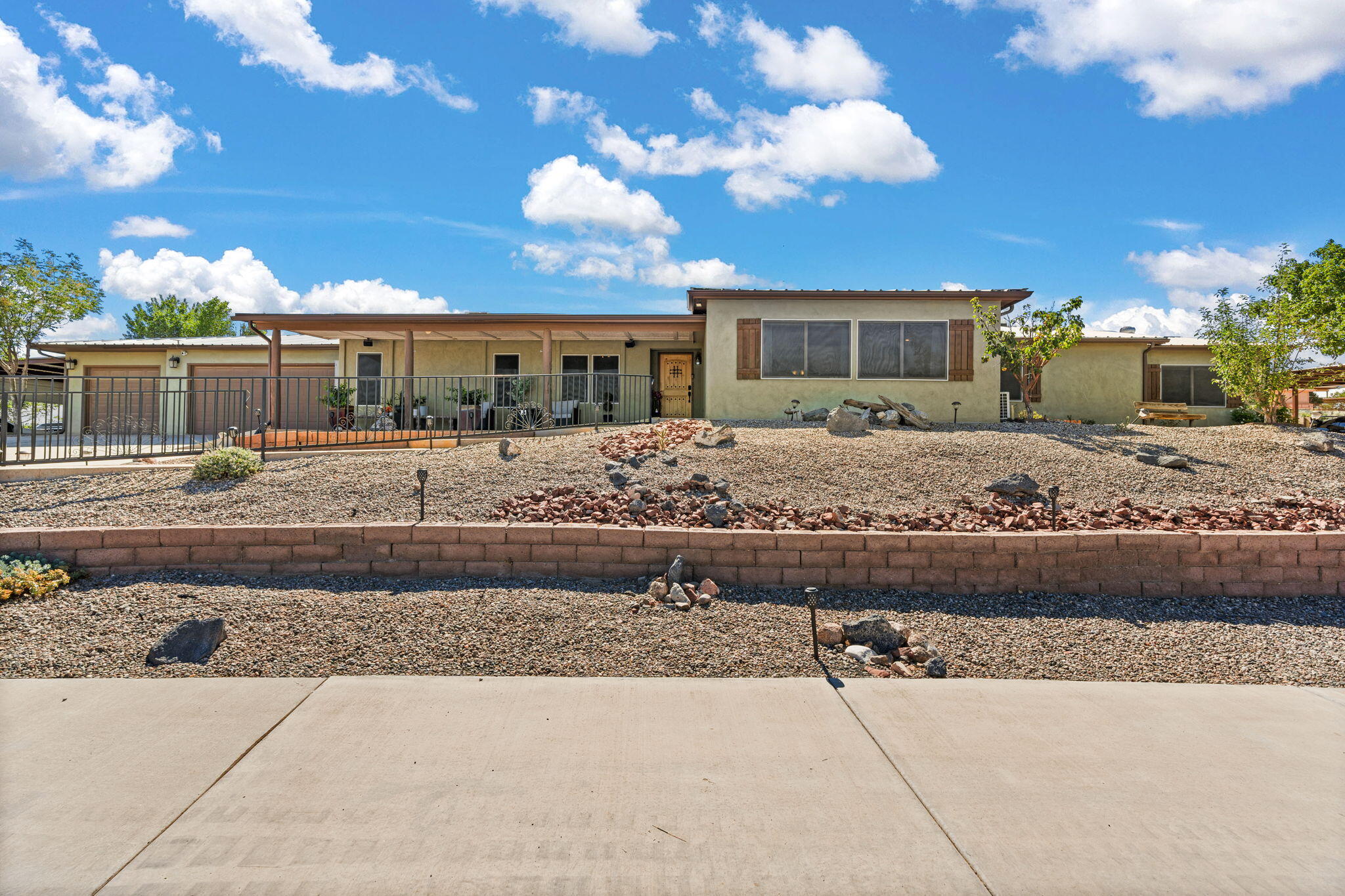 Welcome to this beautifully updated 4-bedroom, 3-bathroom home offering 3,298 square feet of spacious living with mountain views! This home combines modern luxury with outstanding outdoor features. Recently remodeled, this home boasts updated granite countertops, cabinetry, and high-end appliances, while the bathrooms offer sleek, contemporary finishes. The gated driveway leads to an attached 3-car garage and 3 additional detached carports--perfect for the car enthusiast, offering ample space for vehicles, toys, or a workshop. This home is fully powered by paid-off solar panels, helping you save on energy costs. Step outside to a backyard oasis like no other. Enjoy an inground pool, covered patio, gazebo with an outdoor kitchen, and a large turf area ideal for kids to play.