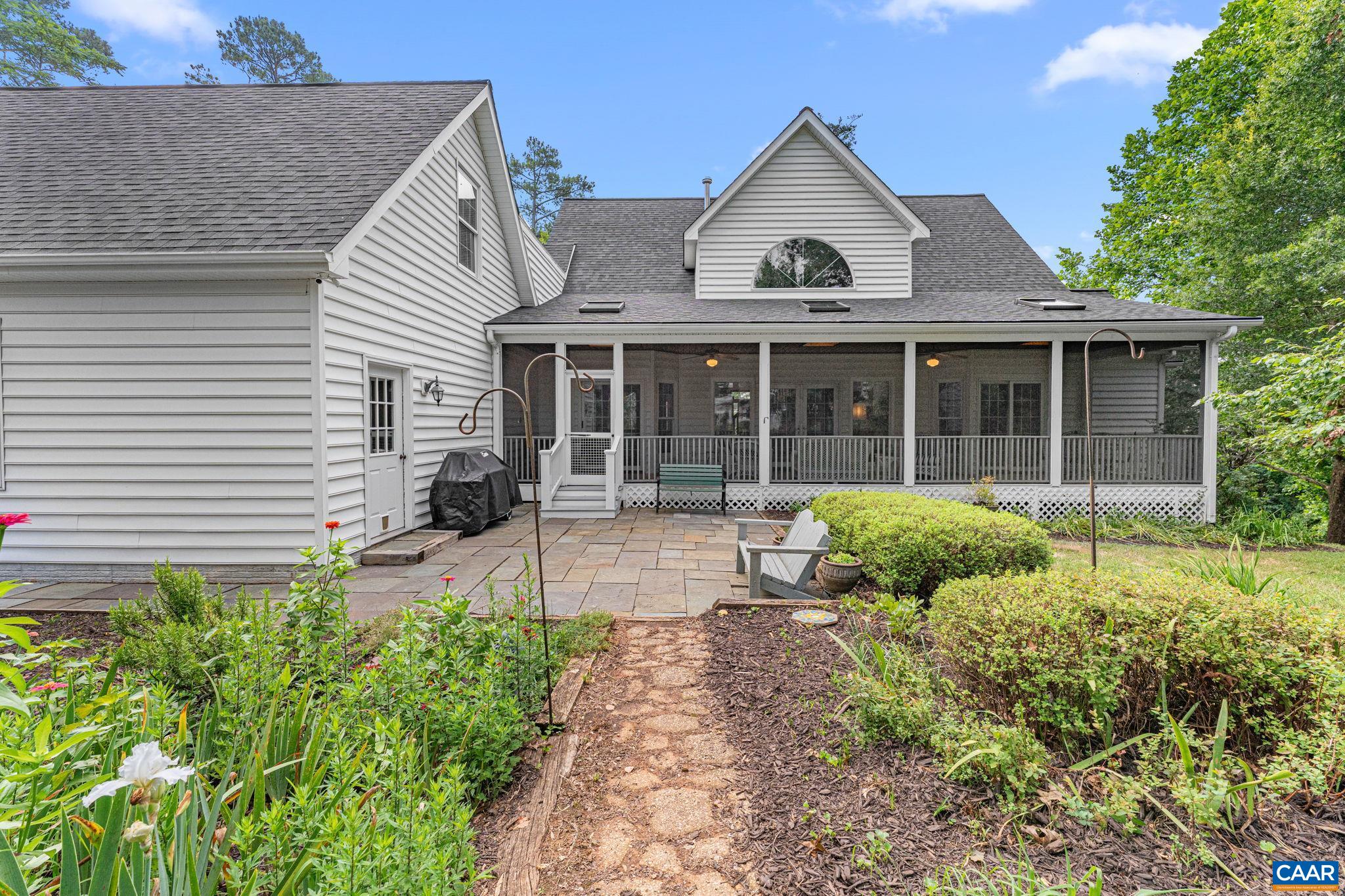 Rare opportunity to enjoy the best of both worlds—private, spacious home along with a charming vintage cottage, all sited on on 6.03 acres just steps from downtown Scottsville! This beautifully maintained home offers a stunning interior with tall ceilings, natural gas fireplace, formal dining room, and a main-level primary suite featuring a jetted tub and steam shower. The spacious screened-in Southern-style patio with skylights is perfect for relaxing or entertaining, and the attached two-car garage includes a large unfinished space above—ideal for future expansion or storage. Finished walk-out basement has a private entrance, adding versatility for guests or a home office. The home also features a natural gas whole-house generator for added peace of mind.    Step outside to enjoy the meticulously landscaped yard, established garden areas, and a powered workshop for your hobbies or projects.   The cottage is ideal for extended family stays, guests, or rental income. It features a full kitchen, full bath, comfortable living room, and additional versatile rooms to suit your needs.