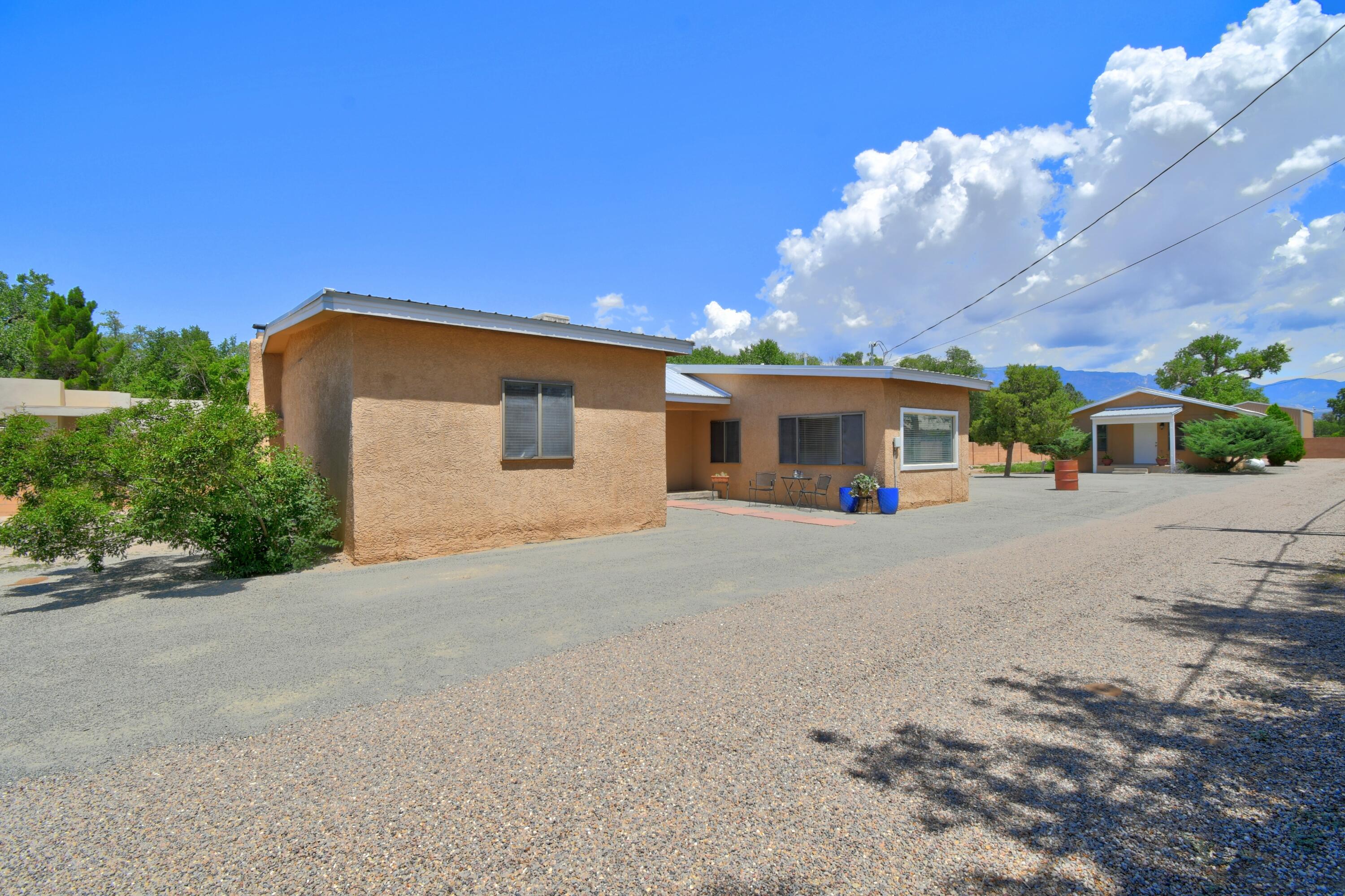 Welcome to this unique & special property on .58 beautiful acres in the Far North Valley. Tucked just east of 2nd Street into an established, tree lined & quiet neighborhood, this property is convenient to walking trails, shopping & restaurants. Upon entry, the main home greets you with a expansive living room containing wall to wall built-ins & a wood burning fireplace. Inside this 3 bdrm, 1 bath 1488 sq. ft. main home, you will find beautiful updates for the kitchen, bathroom + laminate &  aggregate concrete flooring. The adorable casita is 720 sq. ft. contains 1-2 bdrms plus a full kitchen & bathroom. A convenient 132 sq. ft. laundry room is accessible for both homes which are move-in ready & also offer unlimited potential. Come see it today!
