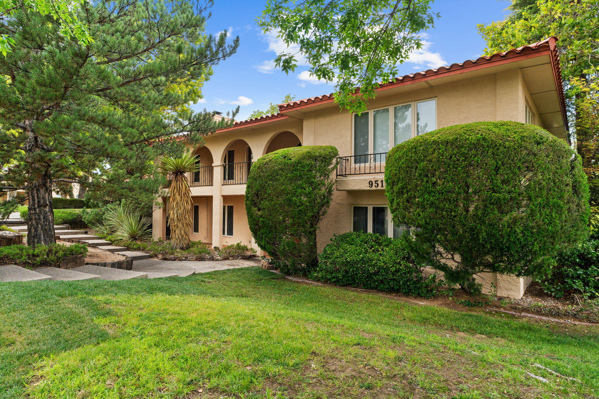 Exquisite Tanoan home situated on oversized corner lot in Abq's premier gated Golf community. This property exhibits exceptional pride of ownership thru-out. Featuring gorgeous engineered hardwood flooring, wood beamed ceilings; refrigerated air; Navien instant hot & exterior Re-Stucco 5/25! Remodeled custom kitchen boasts quartz counters; high-end SS appliances, commercial grade 6 burner gas stove; pot filler; island & eat at bar. Both formal & informal living/dining spaces, ideal for gatherings. 4 bedrooms w/1 bdrm on main floor, & 3 remodeled bathrooms. Primary Suite w/his & her walk-in closets & remodeled spa like en suite w/soaking tub. Oversized garage has epoxy floors, workbench, & storage. Relax Outdoors on the balcony or under the pergola amid the lush landscaping.