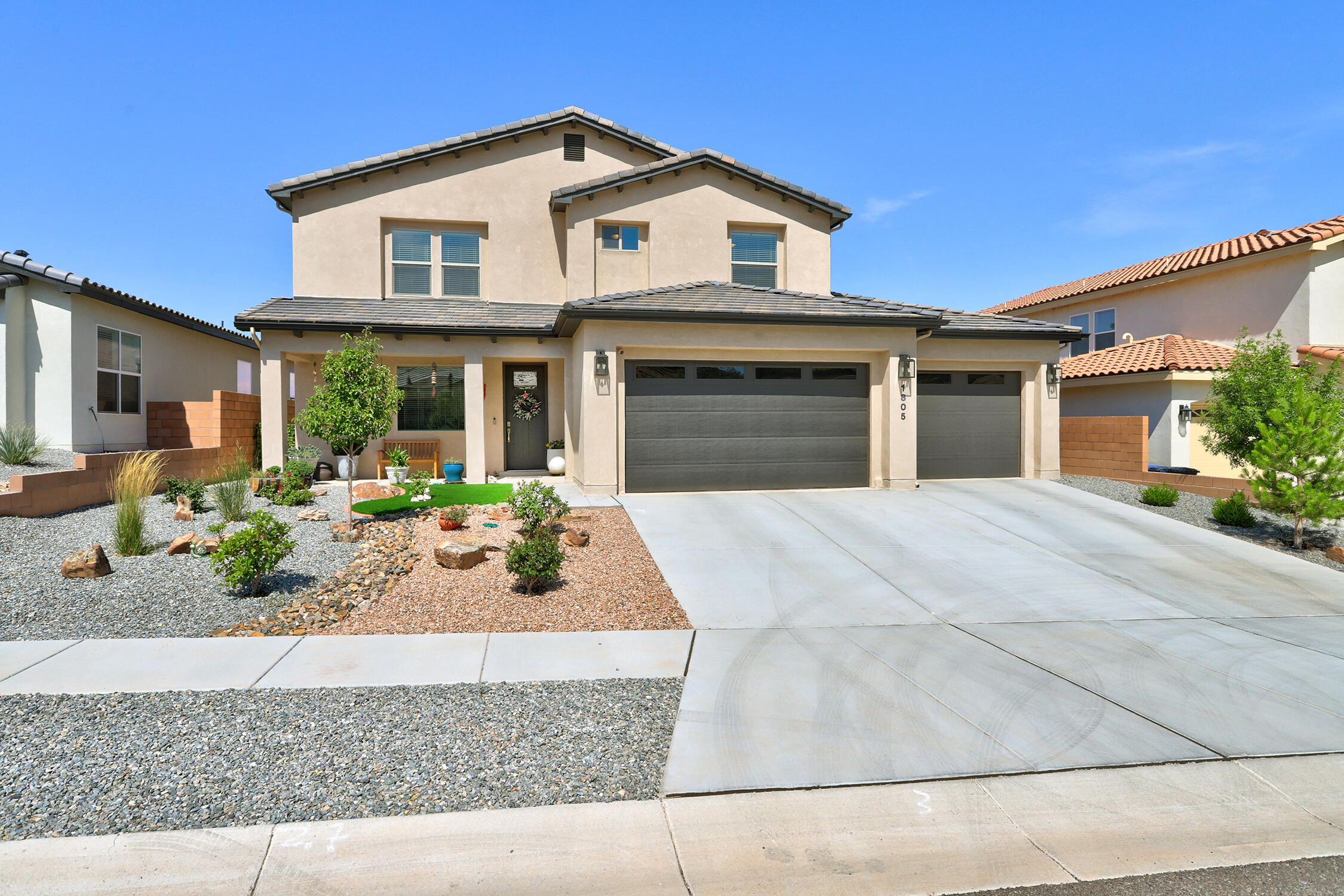 Close to Sandia Labs & AFB, this gorgeous 2023-built RayLee home offers 4 bedrooms (1 on main level), 3 baths, versatile loft, and a dedicated office or 5th bedroom on the main level. The open-concept living/dining/kitchen area features a quartz island, gas stove, pantry, and gas fireplace for cozy evenings. Large sliding doors lead to a shaded patio and pergola, perfect for outdoor living. Upstairs, the primary suite boasts a private covered deck to relax amid sunset views, joined by two more bedrooms, a full bath, laundry room, and loft. The spacious three-car garage includes a rear-facing exit door, by new shed. Every detail is thoughtfully curated - from the curb appeal to the lush gardener's backyard retreat - this home hits the mark!