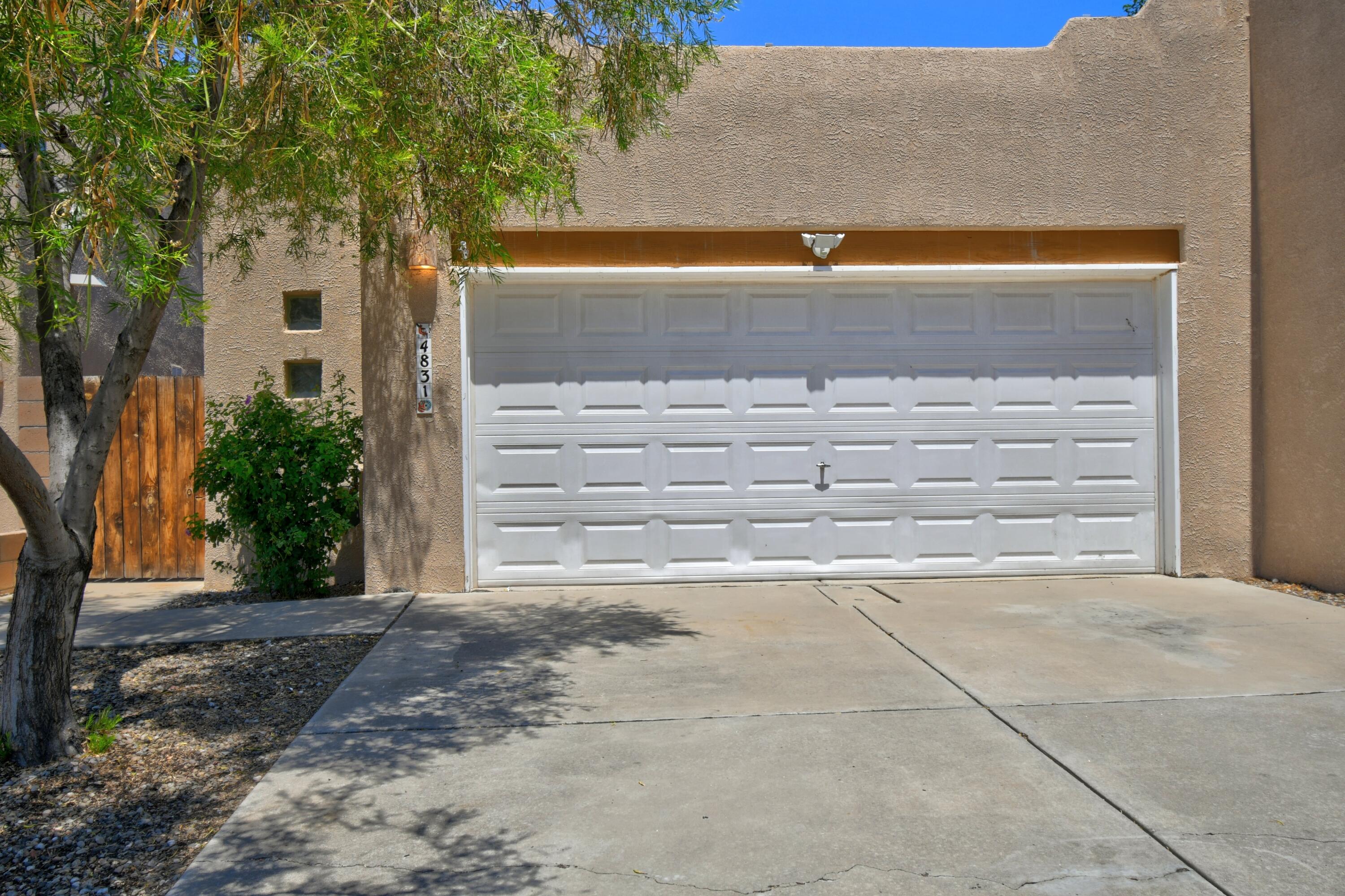 Beautifully maintained two bedroom, two bathroom, two car garage townhome ready to move into today! Soaring 10 foot ceilings, 18 inch tile throughout, and a kiva gas fireplace creates a bright and welcoming living space upon immediate entry.  The open concept floorplan leads right into the kitchen with wood cabinets, quartz counter tops, brand new gas stove/oven range installed July 2025.  The two generously sized bedrooms have new luxury vinyl installed July 2025.  The oversized primary bedroom has direct access to the back yard patio, making it light and bright, and a large and beautifully updated ensuite bathroom, followed by a huge walk in closet.  This home is minutes from shopping, restaurants, and freeway access. Schedule your showing today!