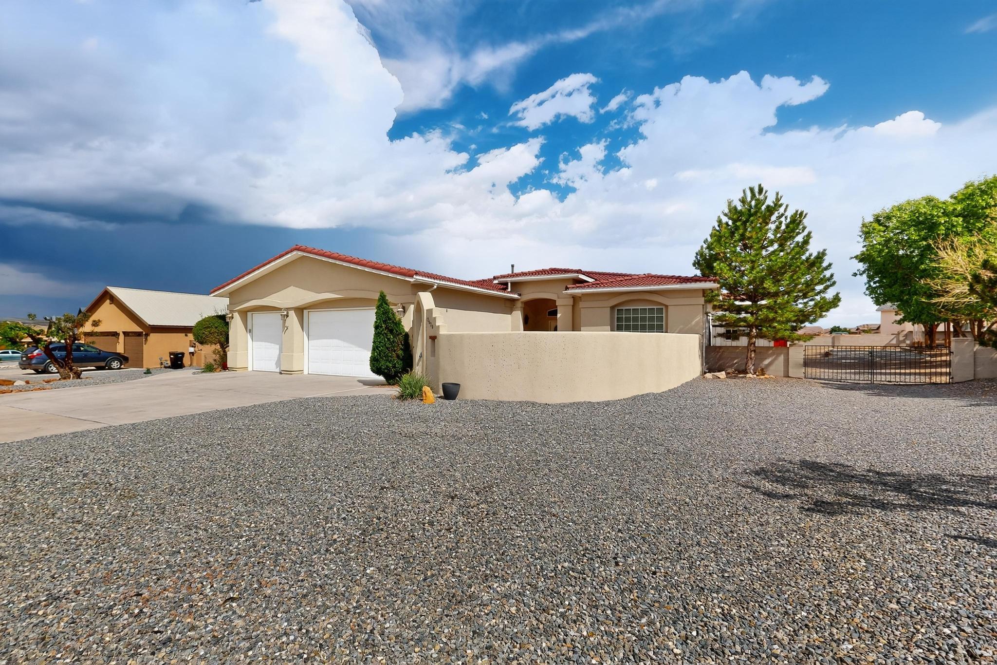 Stunning 3-bedroom + office (or 4th bedroom/flex space) home on a spacious 0.5-acre lot in beautiful Rio Rancho! This 2,401 sq ft home offers soaring ceilings, a granite kitchen island, walk-in pantry, jet tub, gas stove, and recent upgrades including a new dishwasher, fridge, reverse osmosis system, and heater (2024). Enjoy luxury vinyl flooring throughout (except bedrooms), an in-house vacuum, and a spacious laundry room with abundant storage. The fully landscaped, xeriscaped yard is a dream--featuring mature trees, bubble drip system, XL covered patio, fire pit, hot tub/spa area, RV parking, 2 sheds, a fenced garden, backyard access, and a walled yard. Located just minutes from parks, groceries, and more. This rare gem blends style, space, and convenience--schedule your showing today!