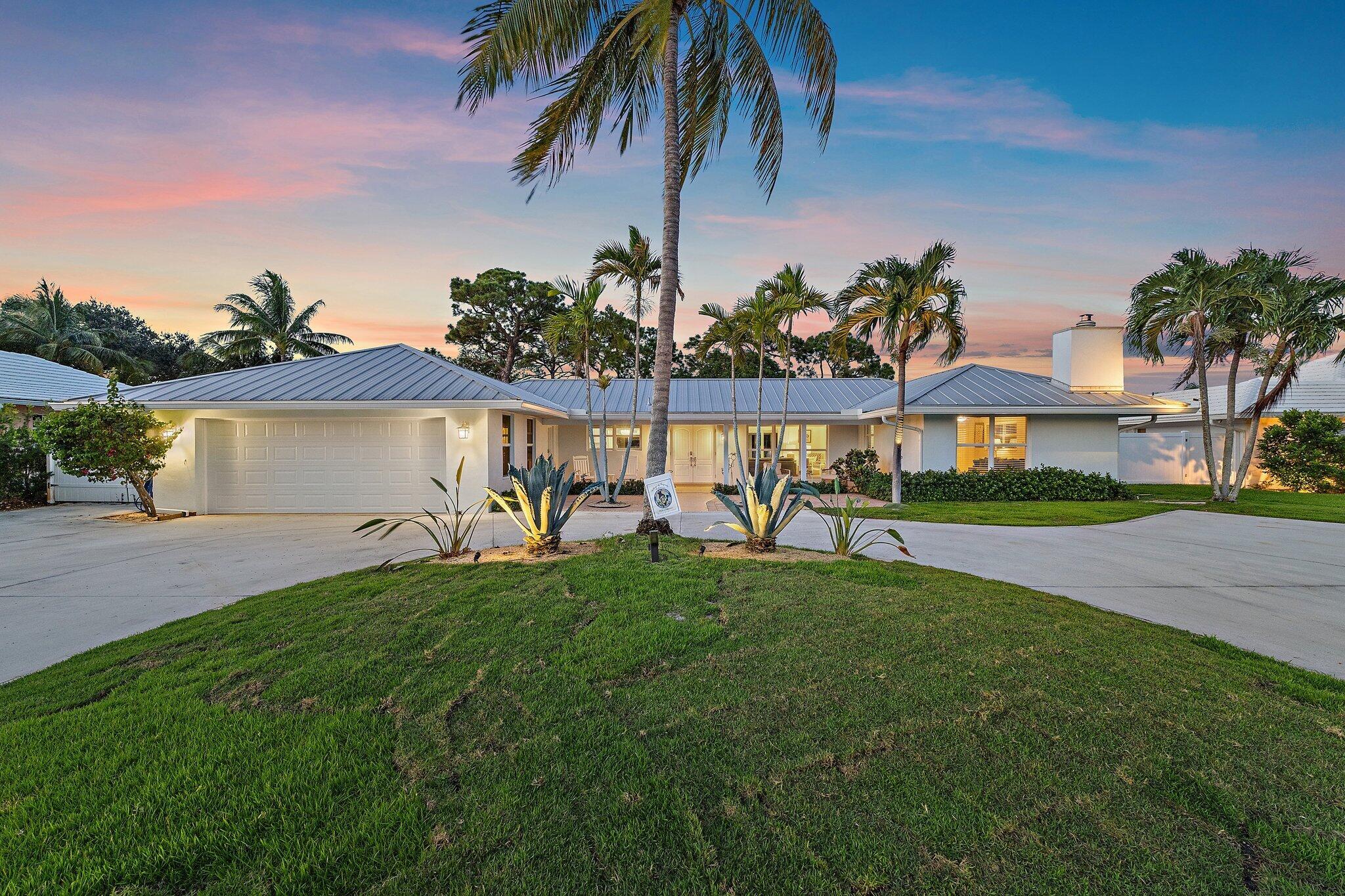 Panoramic golf course views from this beautifully remodeled 3-bedroom, 2.5-bath CBS pool home in highly desirable Tequesta Country Club--just 400 feet from the community boat dock and ramp. Located on generously sized lot, this single-story property offers lush tropical landscaping, a fenced yard, and space to store a boat or RV. Inside, you'll find white oak wood floors, oversized bedrooms, and a functional split floor plan. One of the guest bedrooms features a cozy fireplace. The fully renovated kitchen includes new cabinetry, appliances, stylish lighting, and a built-in coffee/wine bar. All three bathrooms have been stunningly updated. Step outside to a newly resurfaced saltwater pool with a re-marsited finish, new pool deck, and outdoor shower. Additional highlights include impact glass windows and sliders throughout, cedar-accented front and back porches, motorized patio screen, two newer A/C units, new gutters, updated plumbing, and a new electrical panel. Avocado and Meyer lemon trees, a new concrete driveway, an oversized 2-car garage, and a golf cart are all included. TCC offers riverfront parks, A-rated schools, and close proximity to top dining, shopping, and beaches. No HOA and no golf membership required.
