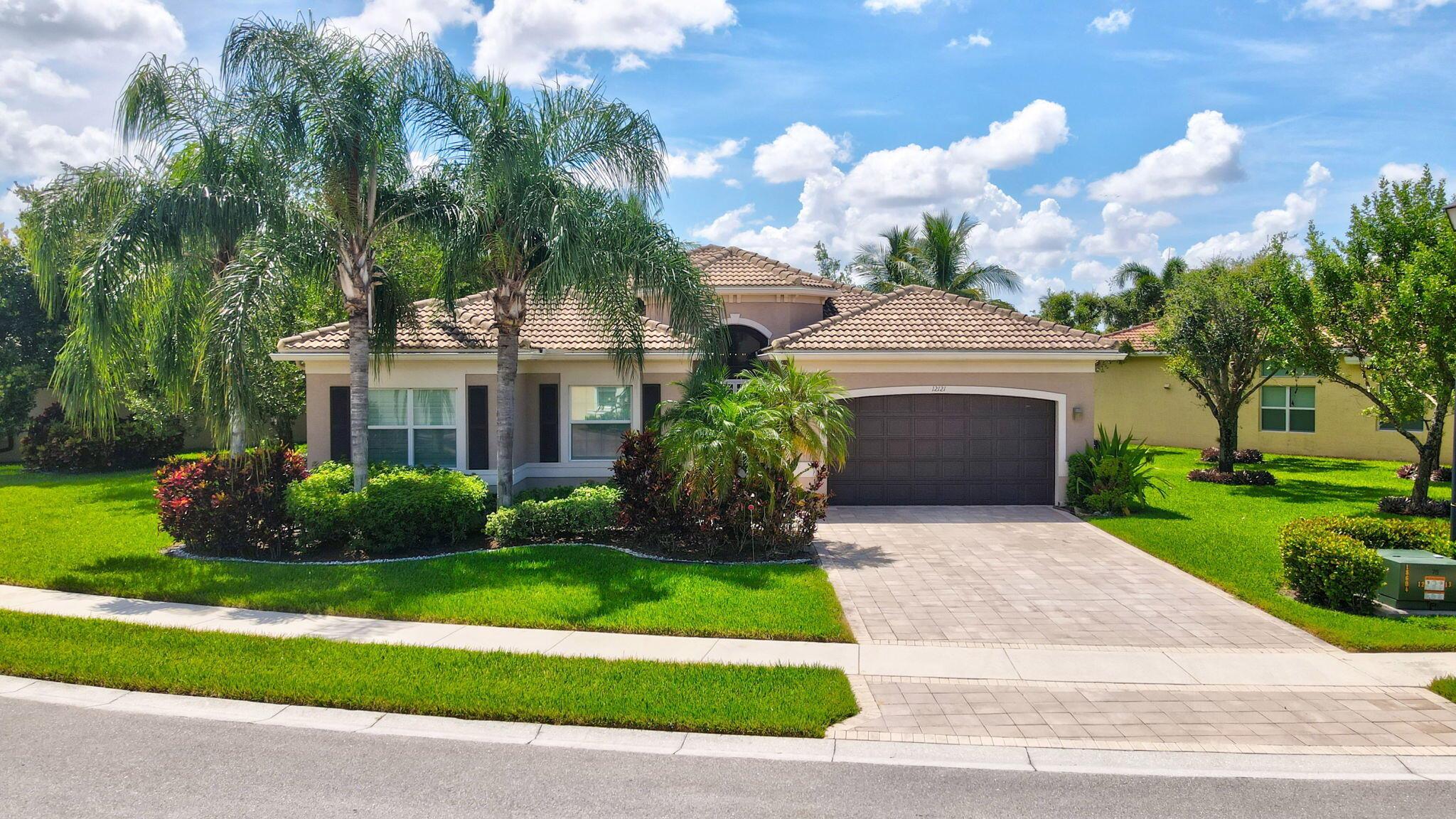 4 Bedroom, 3 Bath 'Lydia' model with over $100K in Upgrades! Situated on a Builder's Premium Oversized Pie-Shaped Lakefront lot offering a widened driveway, walkway and Extended 2CG with Epoxy flooring! Boasting a Newly Painted Interior, Crown molding, Coffered ceilings, abundance of hi-hat lighting, Italian Tile flooring, Wood flooring in bedrooms, Central vacuum, Custom Plantation Shutters, French doors & Designer light fixtures! The Granite kitchen features stainless steel appliances, custom Espresso cabinetry with under cabinet Vent Hood, and center Island! An open floor plan designed for easy entertaining. The family room is open to the kitchen. Formal living and dining rooms. The master suite features custom built-out walk-in closets, upgraded Granite vanity layout with recessed