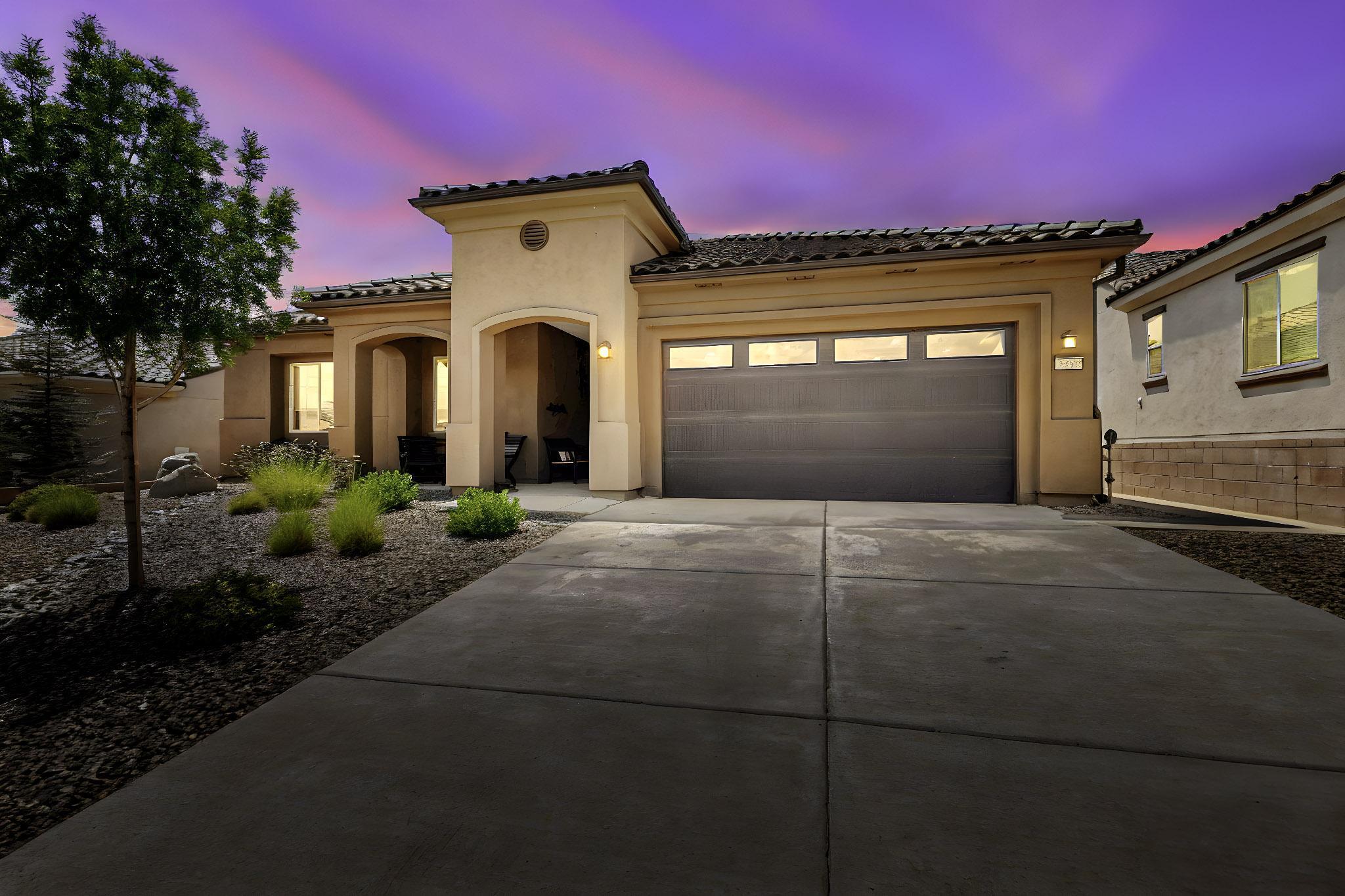 Welcome to Del Webb at Mirehaven--Albuquerque's premier 55+ community! This beautifully maintained 2-bedroom, 2-bath home with a flex den/office offers 2,076 sqft of refined living with just a short walk from private trail access into the Petroglyphs.Interior features include 10-foot ceilings, plantation shutters, and a whole-home water filtration system with softener. The oversized 20' x 30' garage provides generous space for vehicles and storage. Exterior upgrades include gutters and a sidewalk leading to the backyard.Enjoy a backyard oasis with turf, a custom pergola with retractable privacy screen, hardwired pathway lighting, and a remote-controlled awning attached to the covered patio, ideal for outdoor relaxation.