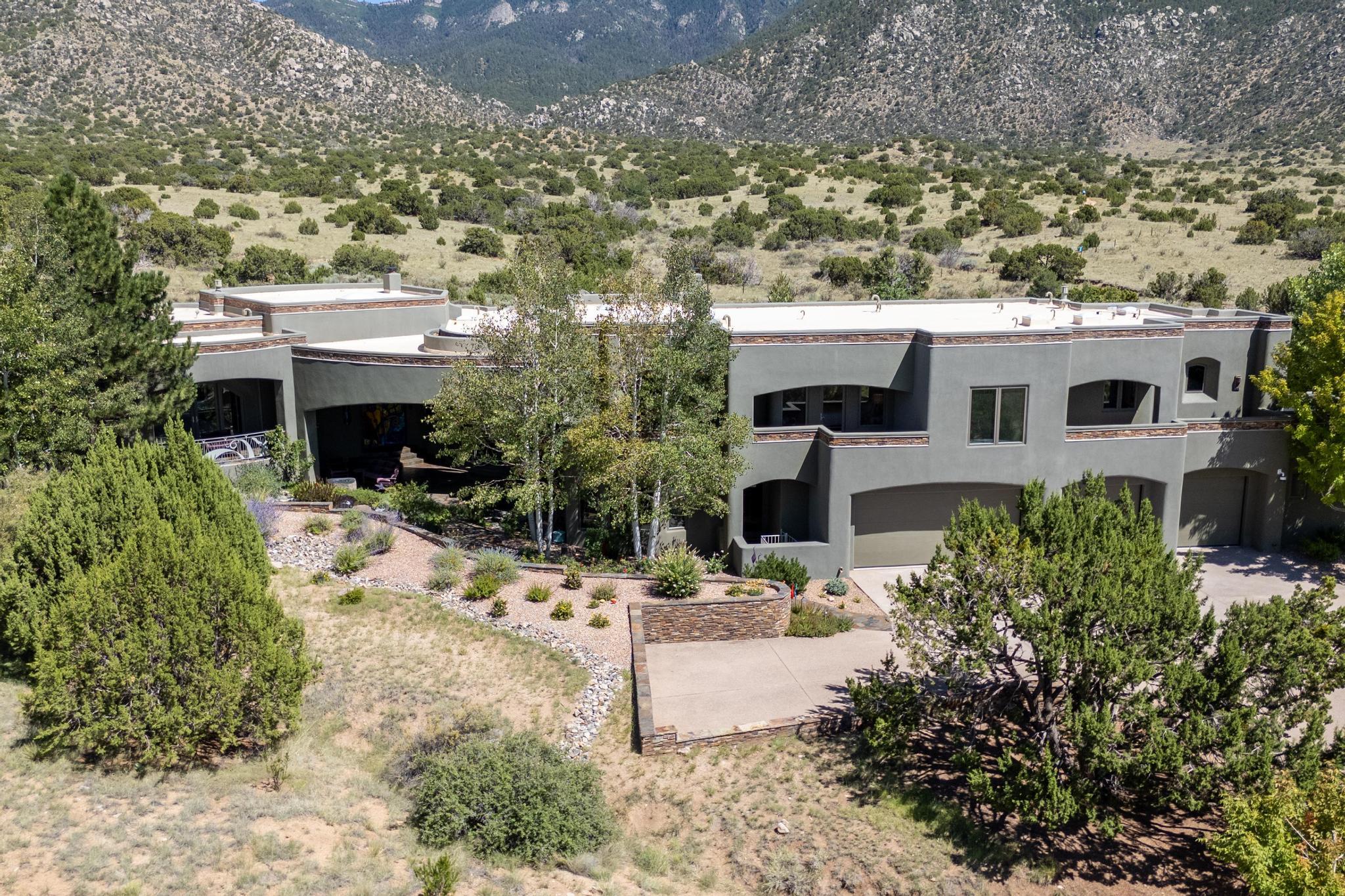 Perched at the pinnacle of High Desert, this extraordinary Custom Built luxury home sits on a private 2.37 acres lot and offers National Forest Views, unmatched privacy, and masterful design throughout. With 4 dedicated bedrooms, including a self-contained guest suite, plus two flexible rooms perfect for a home office and craft space, this home blends spacious living with thoughtful functionality. As you approach the home, you're greeted by an elegant water feature that flows beside a custom fire pit, creating a stunning and serene entry experience that sets the tone for the rest of the property. Bedrooms/Office all have window and balcony views. creating indoor-outdoor living and maximizing the incredible vistas. Designed for both elegance and practicality... PLEASE CLICK ''MORE'