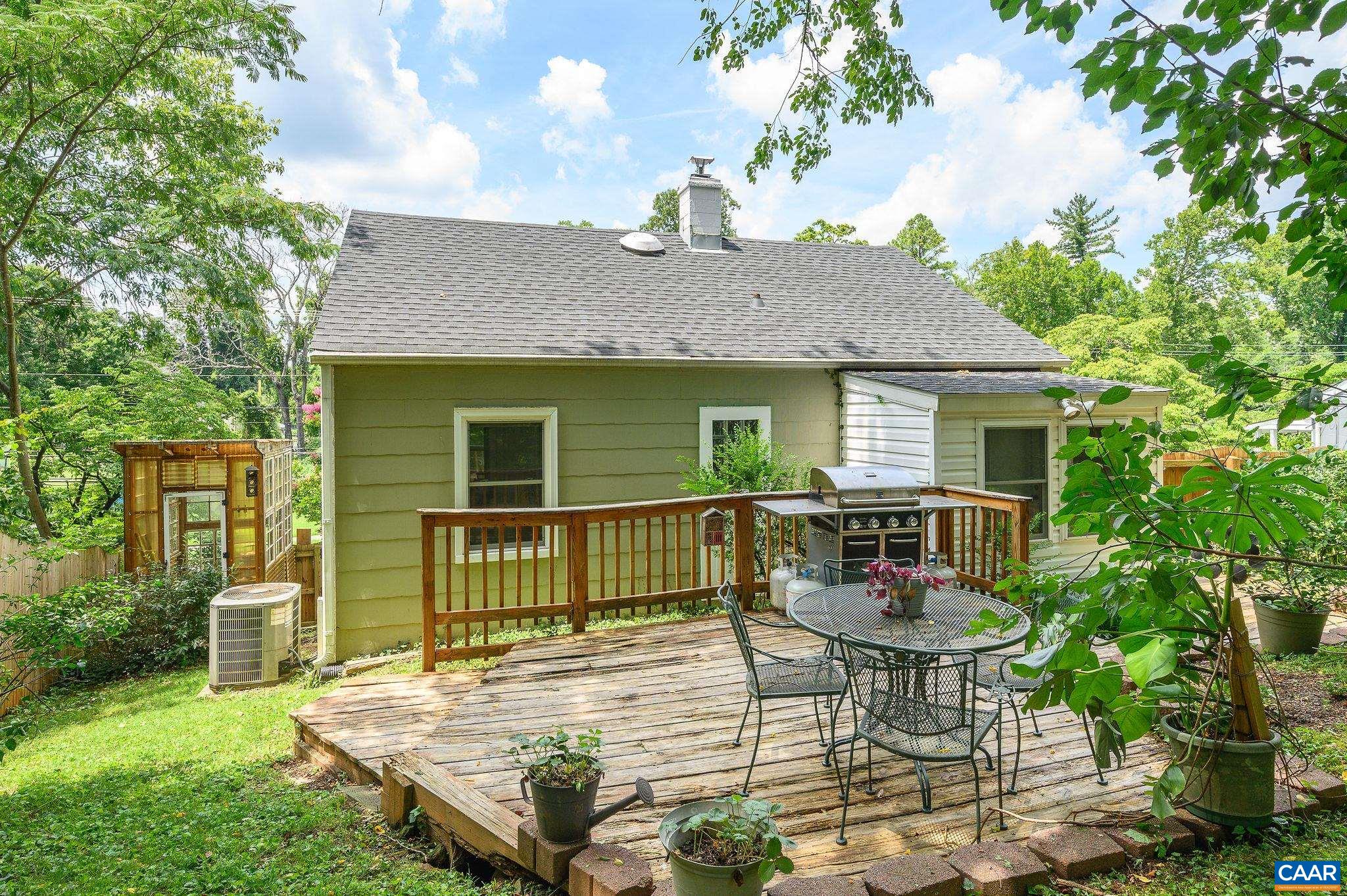 This 1940s North Downtown cottage offers city living with rare garden tranquility. Elevated from the road and nestled among mature plantings, it feels private and peaceful—yet it’s just a 10-minute walk to the Downtown Mall’s shops, restaurants, and entertainment. Inside, original hardwood floors and moldings meet a beautifully remodeled kitchen, a comprehensively renovated bath, and a sunlit dining addition overlooking the backyard. Freshly painted and move-in ready, the home features great natural light, built-ins, and a walkout basement ideal for storage, tools, or projects. The fenced yard is a four-season sanctuary with blooming perennials, peach trees, a raised bed, and a cool greenhouse—perfect for quiet mornings or lively evenings on the deck. A peaceful retreat with community connection, this home has been a true sanctuary—and now it’s ready for its next chapter. SO MANY updates: Windows (2015), Fencing (2017), Furnace/Fridge (2019), Roof/Gutters/Gutter Guards (2021), Water Heater/All new Plumbing (2022), Chimney Liner/Cap (2023).