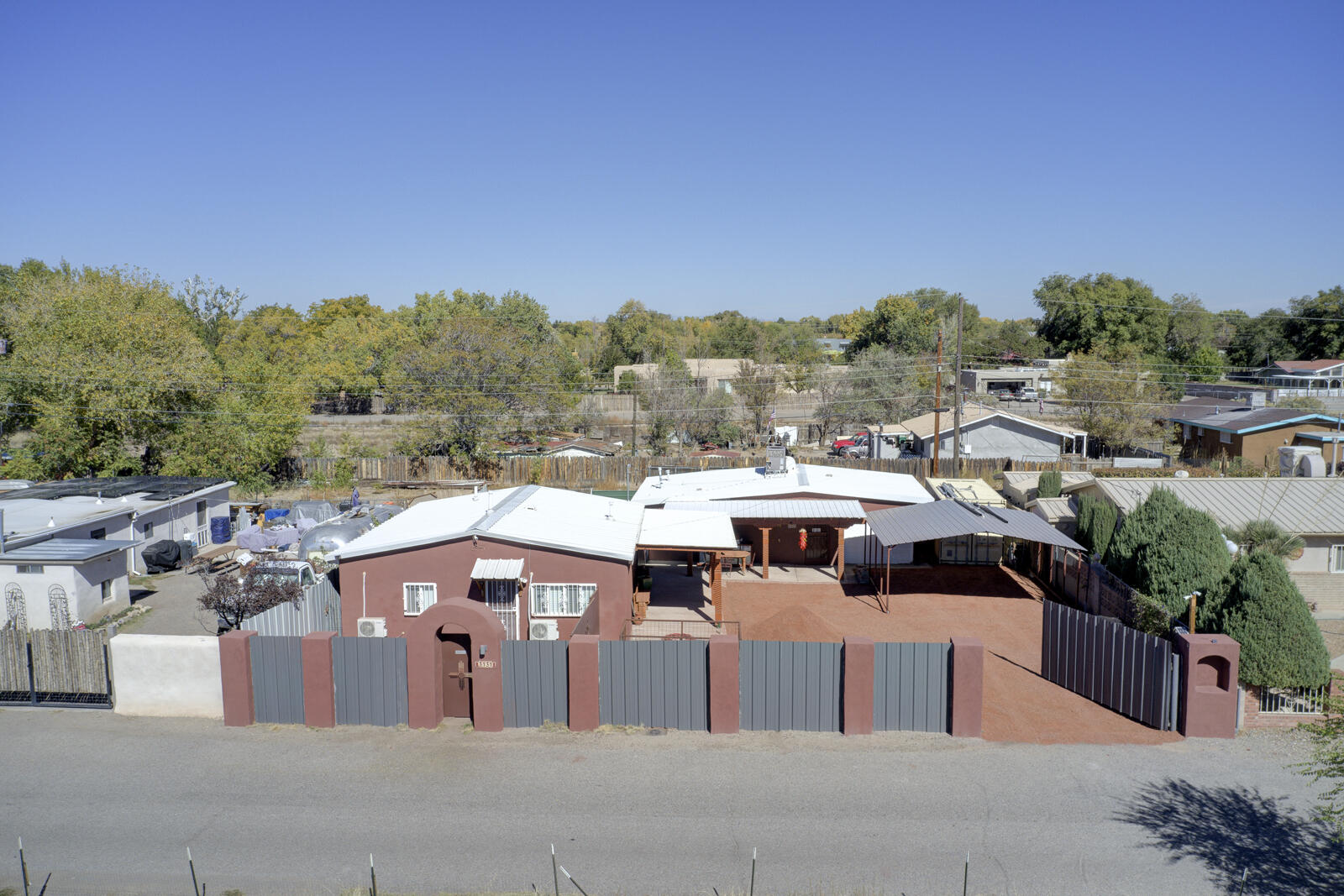 Discover this unique, fully gated property in the coveted Los Duranes neighborhood, featuring two charming houses, each with 1 bed and 1 bath. Enjoy the beauty of New Mexico-style artistic details and luxurious exterior finishes. Each unit boasts its own private enclosed yard, open patio, and convenient carport--perfect for relaxation or entertaining. Ideal for investment or AirBnB hosting, this property also accommodates multi-generational living. The durable metal roofs add to the appeal while ensuring longevity. Nestled near the picturesque Rio Grande River and close to hiking trails and parks, this gem combines comfort with outdoor adventure. Minutes from Old Town, Down Town, Rio Grande Bosque, Los Poblanos.
