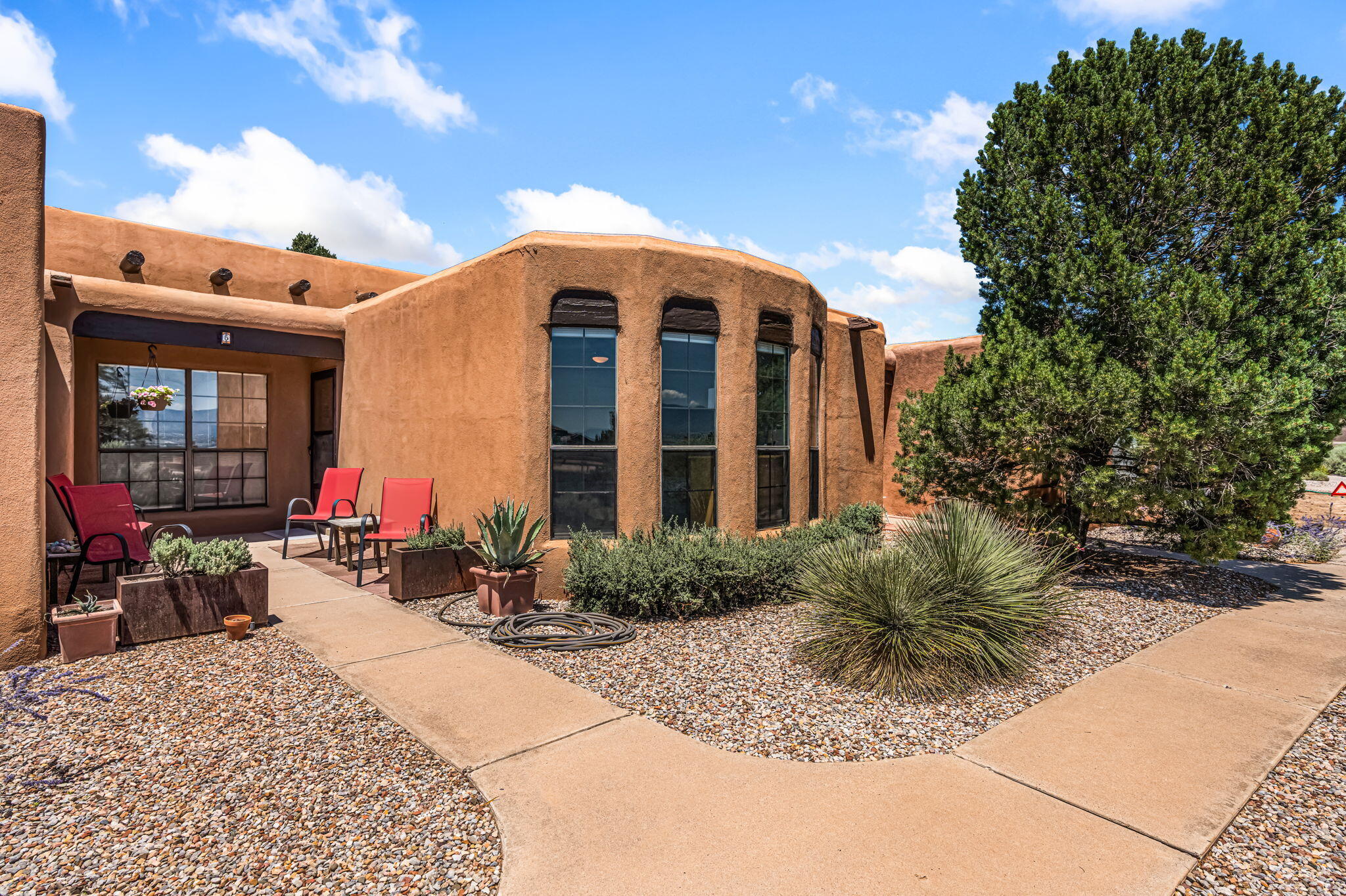Welcome to Pueblo Los Cerros, where views, comfort, and charm come together. This luxuriously updated 3-bedroom home offers warm colors, a great floorplan, and newer roof and mechanicals for peace of mind. The living room features viga & wood ceilings and a cozy kiva fireplace, while the spacious dining area is ideal for hosting. Wake up to mountain views from the private primary suite, set apart for solitude and privacy. Step out to your private patio and garden space with direct garage access--perfect for relaxing or growing herbs. Enjoy community amenities like the pool, tennis courts, and clubhouse in this well-loved neighborhood. Pack your bags, you've found your new place to call home!