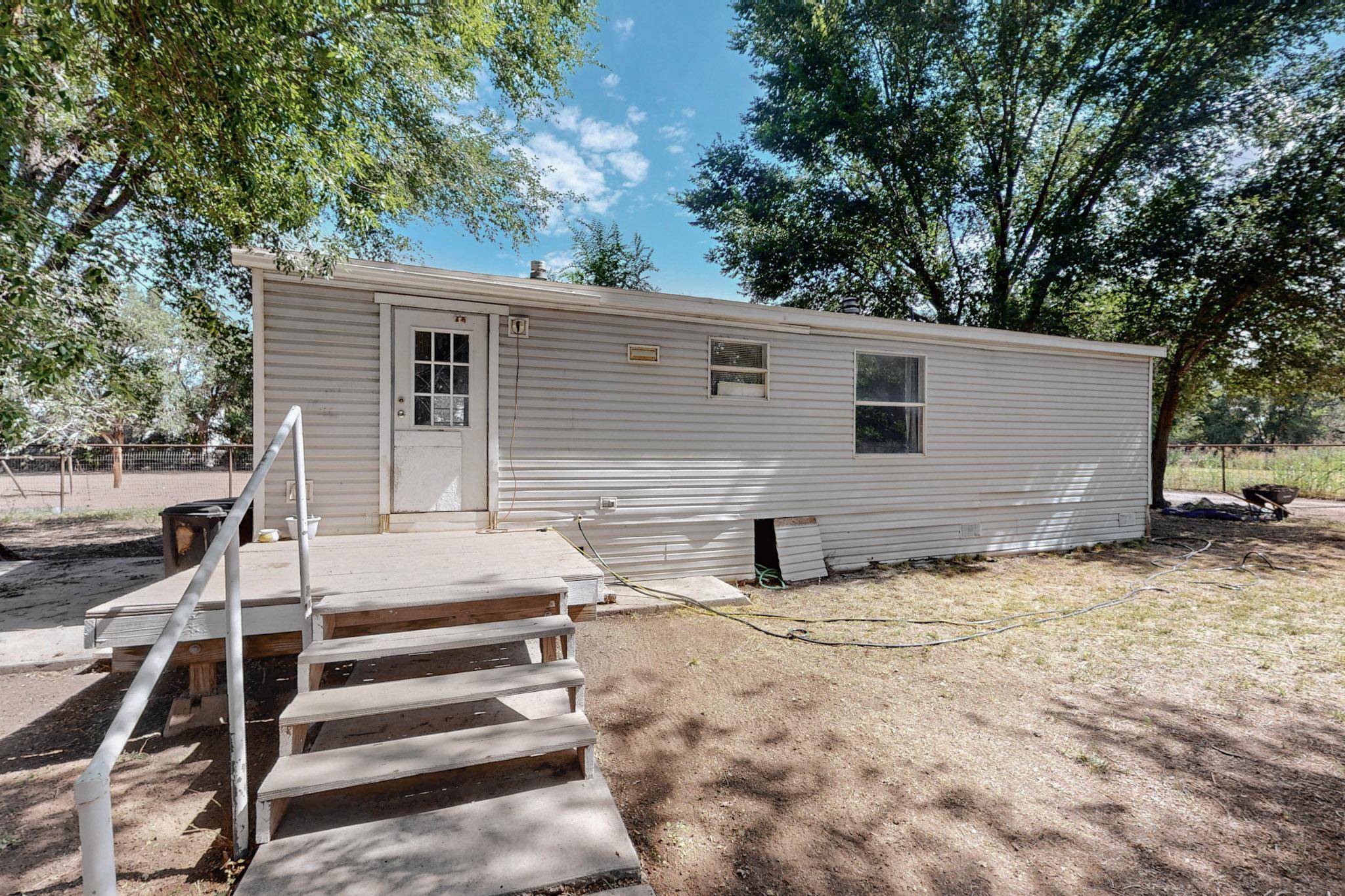 Country Living  On  1.75 Acres in Los Lunas,Bring your horses ! Perfect for handyman , investors, or cash buyers looking for a project. 2 Bedrooms, 2 Bath. Washer & Dryer and Fridge convey. Home is being sold  As-is.    There is plenty of room for your animals, Chicken coop, Horse Barn could be used as a workshop, Fenced  all around. Come  take a look.
