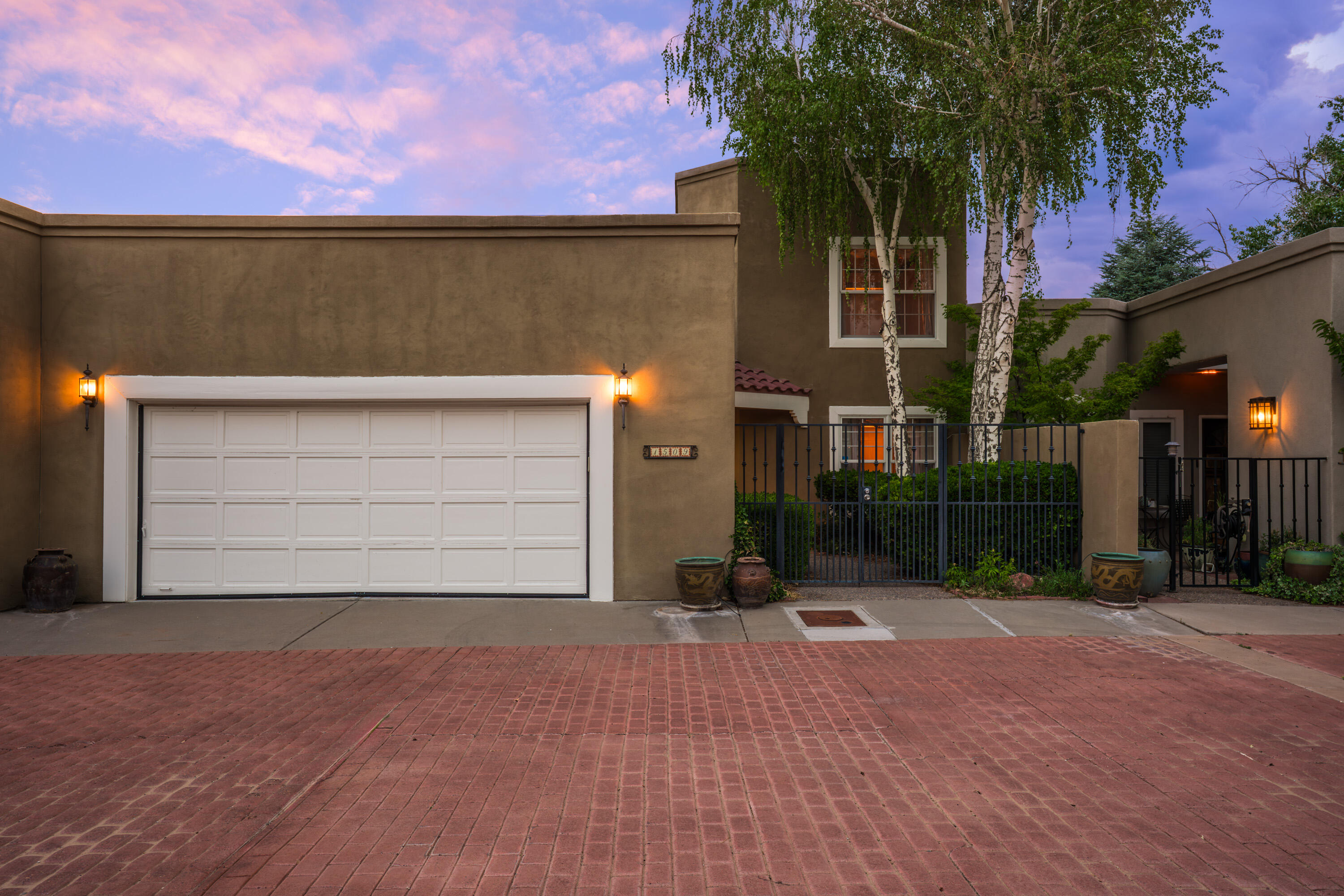 Welcome to 1509 Plaza Encantada, a lovely home tucked inside the gated enclave of Rancho Caballero in the heart of the North Valley. Inviting and charming courtyard with mature trees and landscaping.  Ready for your personal touches, ask about special financing programs available for updates!!  Wood beam and tongue and groove ceilings, clerestory windows and skylights for an abundance of light. Primary suite located on the main level! Built in bookshelves in the upstairs loft with an additional bedroom and charming balcony. Low maintenance backyard.  Trails, parks, pickle ball courts, Los Poblanos, and Flying Star just minutes away. Plus, this well-located neighborhood offers quick access to all of Albuquerque. Discover the perfect blend of community and comfortin this sought-after locati