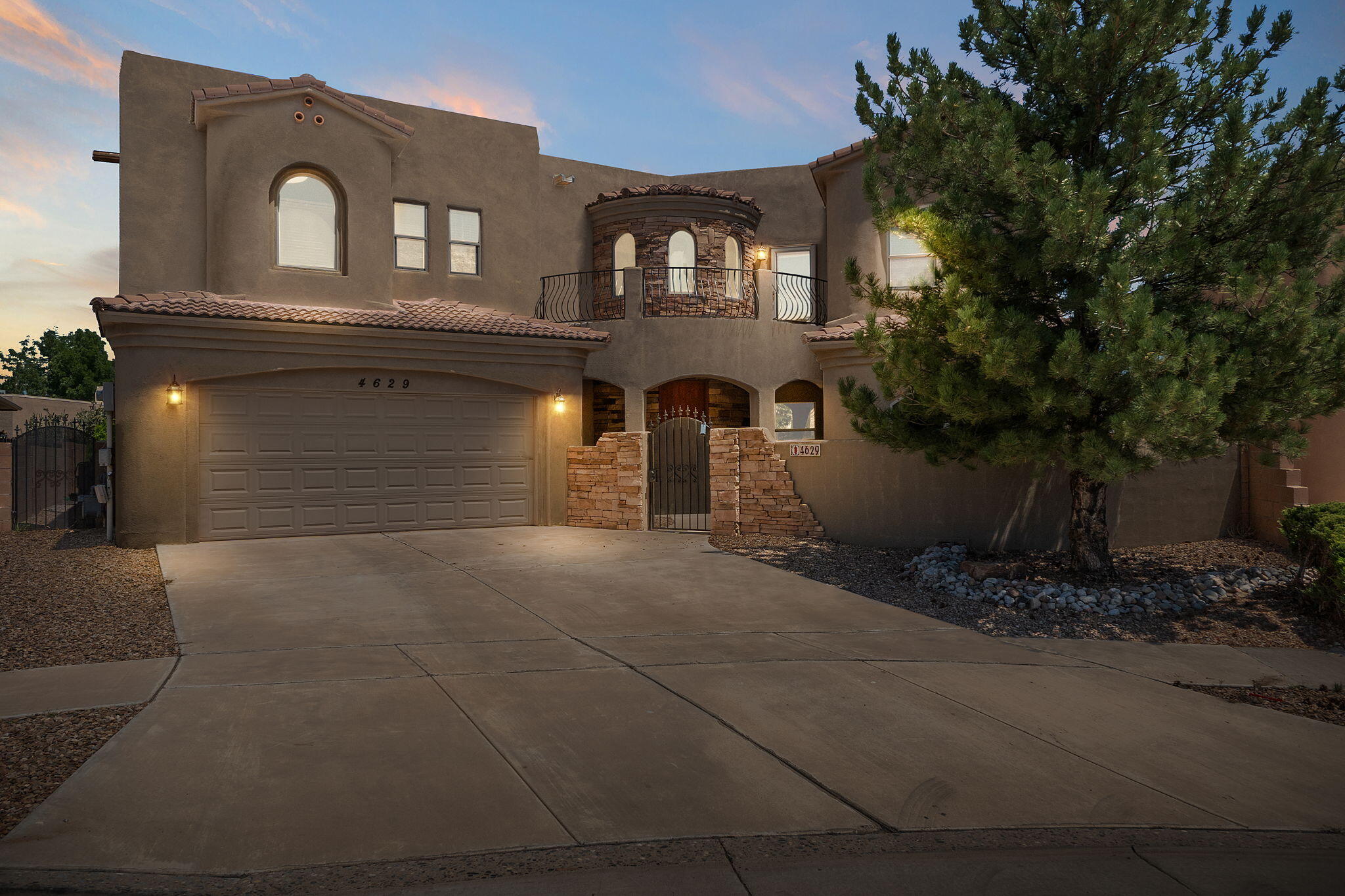 Welcome to an extraordinary custom residence offering 4,074 square feet of refined luxury, thoughtfully designed to balance elegance and functionality. This stunning 5-bedroom, 3-bath home impresses from the moment you arrive, with a charming courtyard entry and striking stone-accented exterior that set the tone for the sophisticated interiors beyond.Inside, you'll find a beautifully updated and freshly painted interior enhanced by modern lighting fixtures that add a contemporary flair. The main level features two generously sized bedrooms and a fully updated bath--ideal for guests, multigenerational living, or a home office setup.Upstairs, the expansive owner's suite is a true retreat, complete with a spa-inspired en-suite bath.
