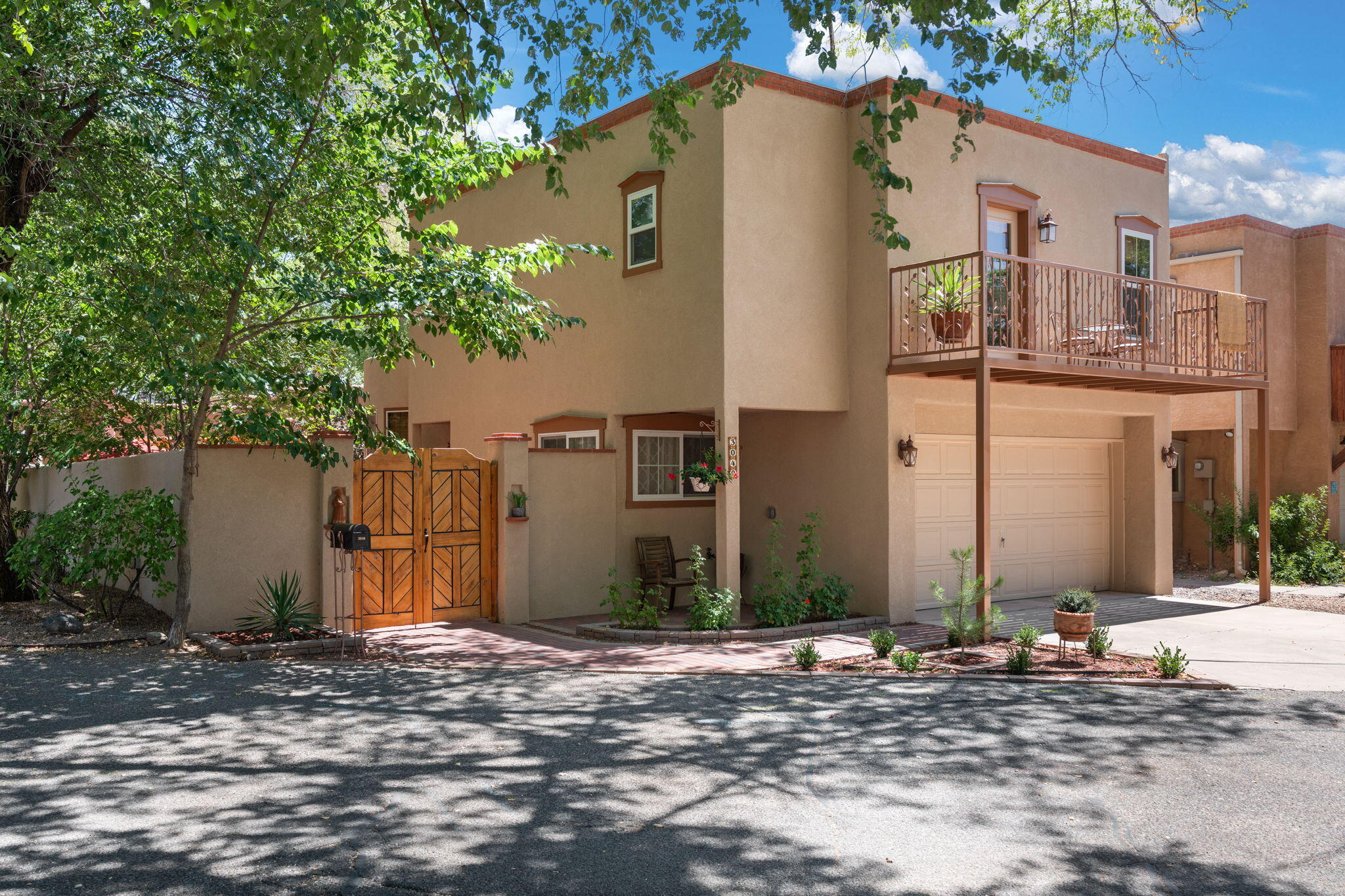 North Valley charm just minutes away from the Rio Grande Nature Center and Bosque hiking/biking trails. This cute 2 bed 2.5 bath home has been totally remodeled from top to bottom! Brand NEW TPO roof, refrigerated air/HVAC, flooring, windows, synthetic stucco, kitchen and bathrooms. Downstairs has refinished brick floors and a kiva fireplace. Kitchen features new cabinets, quartz countertops, a farm sink and all new appliances. Upstairs has new laminate flooring and two good sized bedrooms. Enjoy your morning coffee on the balcony surrounded by shade from the overhanging Cottonwood trees. The backyard oasis is fully fenced with all new landscaping, sprinklers and drip system for stress-free maintenance. You will instantly feel at home the second you walk through the door!