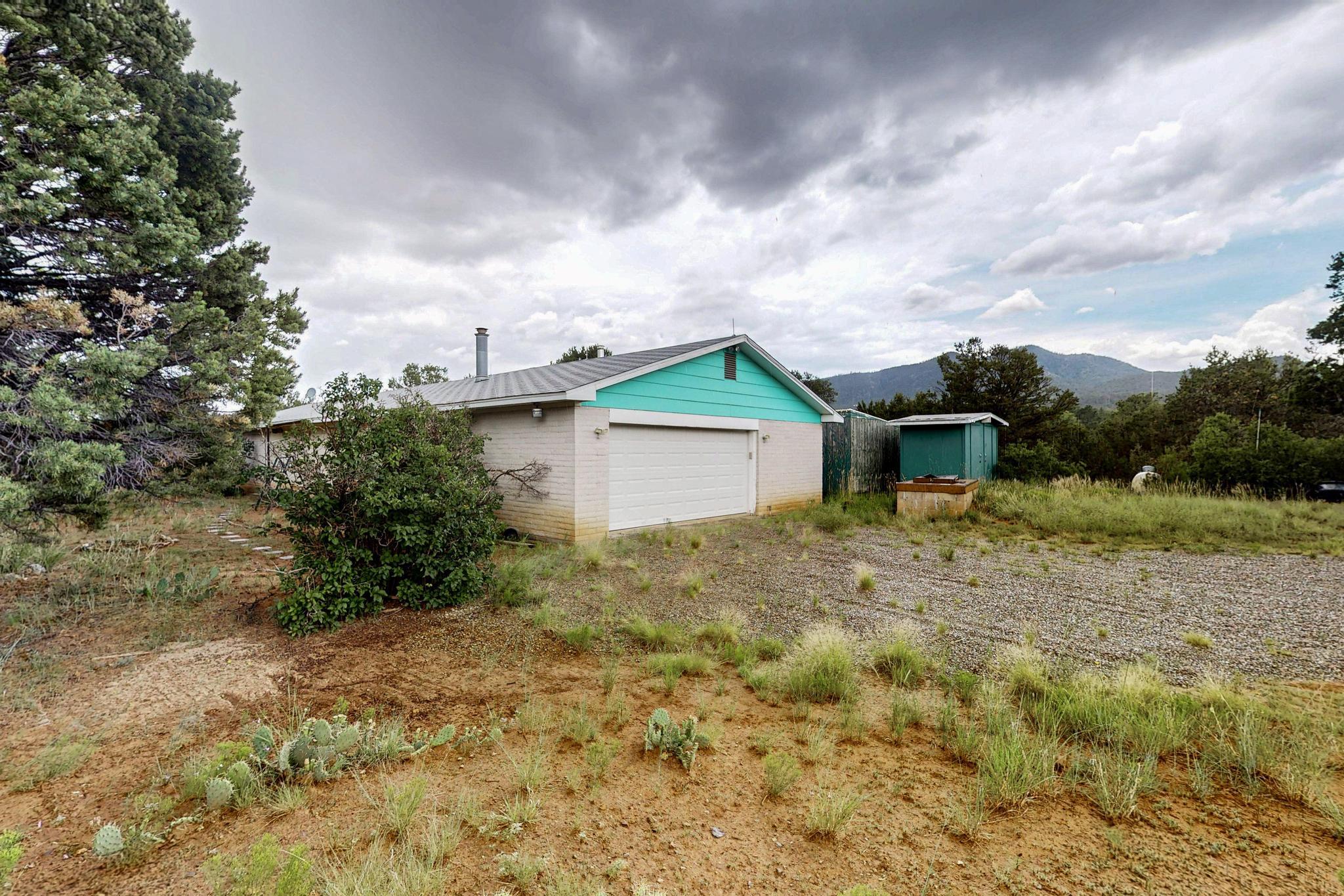 Charming 3-bed, 2-bath home on 24 peaceful acres in beautiful Sandia Park. This 1,800 sq ft residence offers open living, natural light, and serene mountain views. The property includes a rustic log cabin, ready to be transformed into a guesthouse, studio, or rental--an ideal blank canvas for your vision. Zoned A-2, with room for horses or gardening, this property combines privacy, space, and potential in one of New Mexico's most scenic high-desert settings. A rare opportunity!