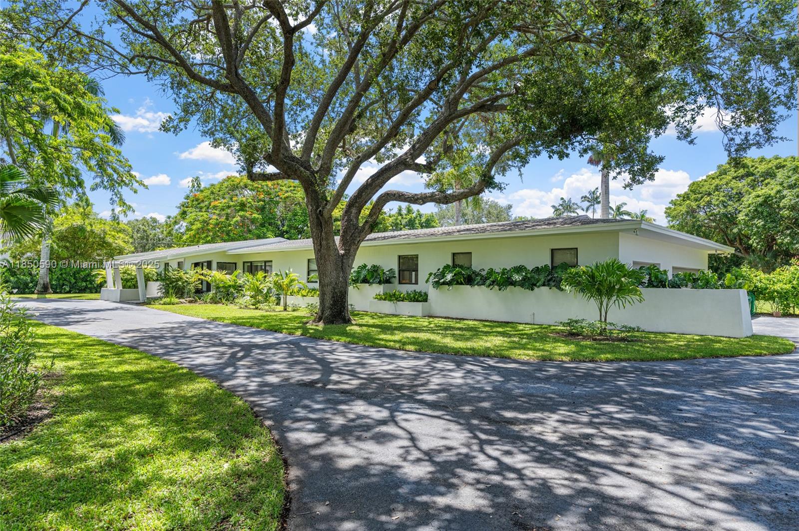 Experience charm and comfort in this tastefully updated Pinecrest residence offering 7,000 sq ft,  on a lush 39,204 sq ft lot (a builders acre). Nestled among mature tropical landscaping, this home features 6 bedrooms, 6.5 baths, a seamless layout w/ expansive living areas & views of the beautifully landscaped yard & pool. A few of the highlights include Spanish gray tile flooring, classic wood kitchen cabinetry with black granite countertops, travertine bathrooms, a 1,600 sq ft primary suite w/office & an oversized closet. Enjoy a large covered terrace, 3-car garage, sauna, two laundry rooms, impact windows & doors, and more. Fully fenced & privately situated on a quiet, desirable street in the Village of Pinecrest — this is a rare opportunity to own a truly exceptional home.