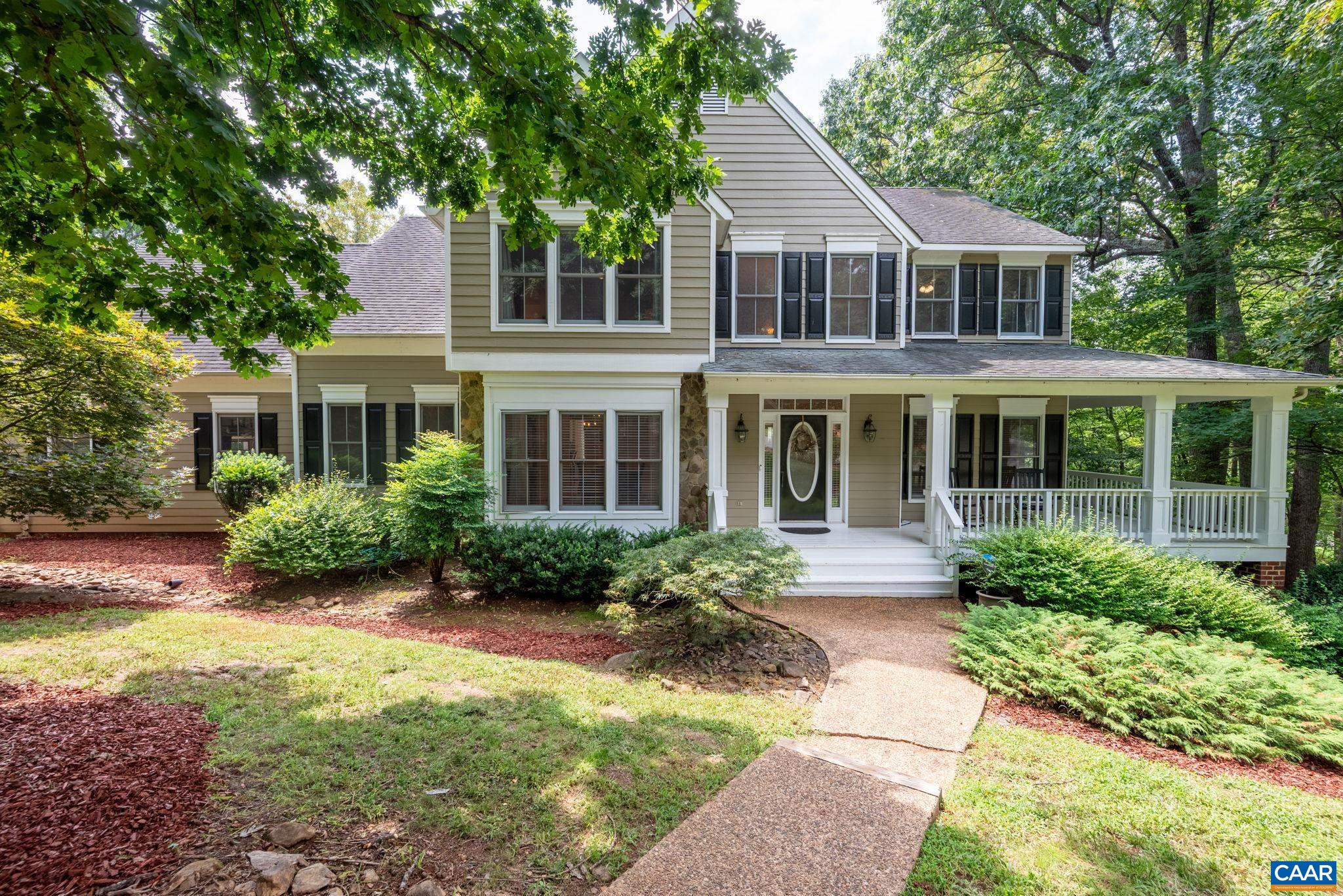 Perfect for multi-generational living! The finished walkout terrace offers a full primary suite, kitchen, living room, and private entrance. Welcome home to 515 Lego in the desirable Ashcroft neighborhood just east of the City of Charlottesville just 10 minutes to downtown Charlottesville, 5 minutes to Martha Jefferson Hospital campus, and a couple minutes to the 64 interchange. Immaculate sun-drenched colonial on 2+ acres backing to wooded common land! This 5BR/3BA home features wrap-around porch, updated eat-in kitchen with Viking range, granite counters, center island opening to bright family room with fireplace and built-ins. Entertain on the  deck overlooking the fenced yard perfect for pets. French doors access spacious owner's suite with sitting area, massive 21x7 closet, luxury bath with dual vanities. Finished lower level offers rec room with fireplace. Hardwood floors, 9' ceilings, dual fuel heating, central AC. Short walk to community pool, tennis, playground, and hiking trails with mountain views.