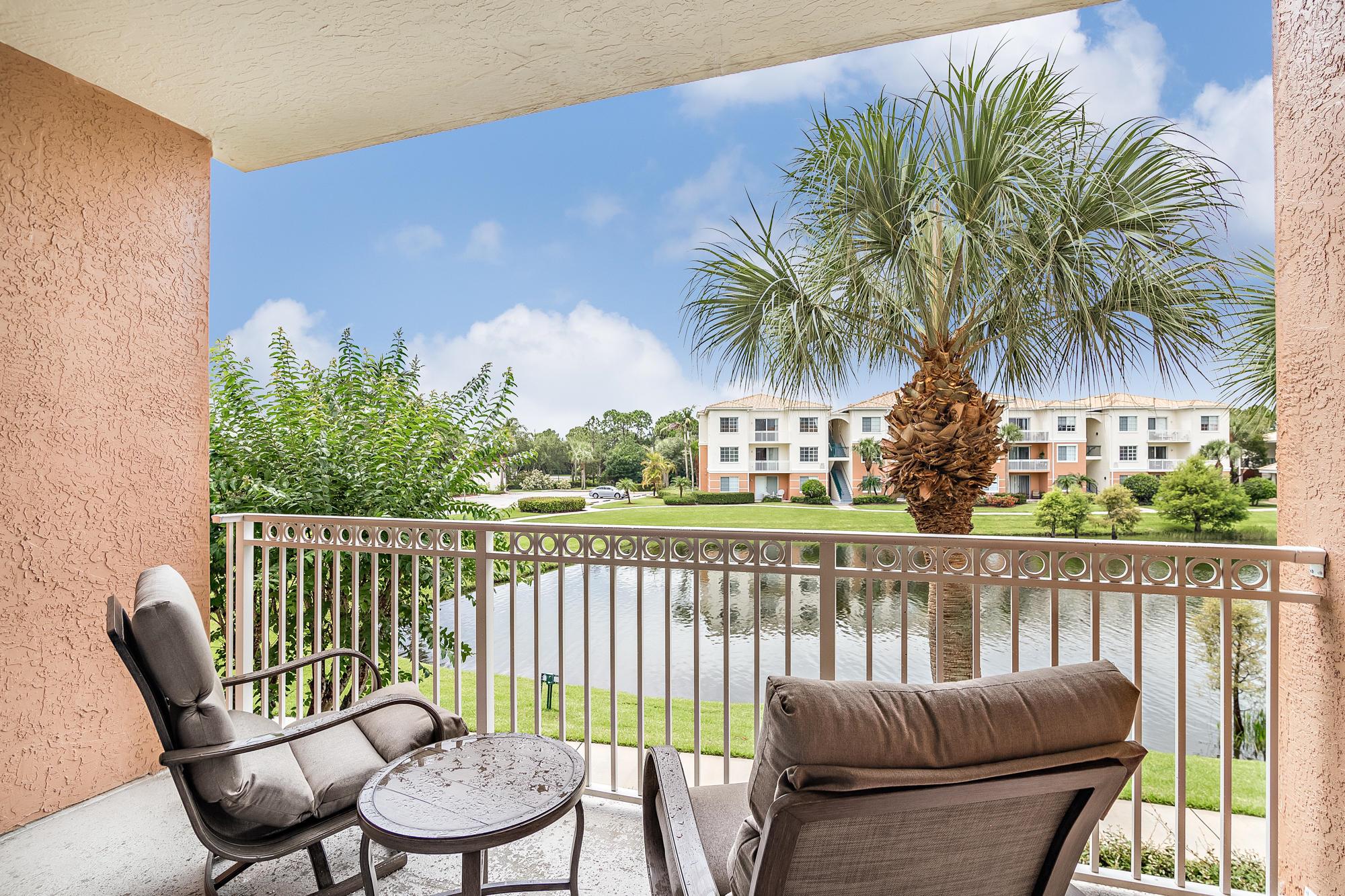 Step into this freshly painted, beautifully upgraded lakefront condo offering 2 spacious bedrooms, 2 full bathrooms, and an attached garage. This light-filled, open-concept unit features elegant engineered hardwood flooring, granite countertops, and a full-size washer and dryer for added convenience. Unwind on the covered patio while enjoying serene lake views. Located on the second floor with southern exposure. Fiore at the Gardens, a high sought after gated community just 5 miles from the beach and close to world-class shopping and dining. Residents enjoy an impressive lineup of resort-style amenities, including a heated pool, clubhouse, cabana, car wash station, putting green, and BBQ grill.  Everything you need for relaxed Florida living.