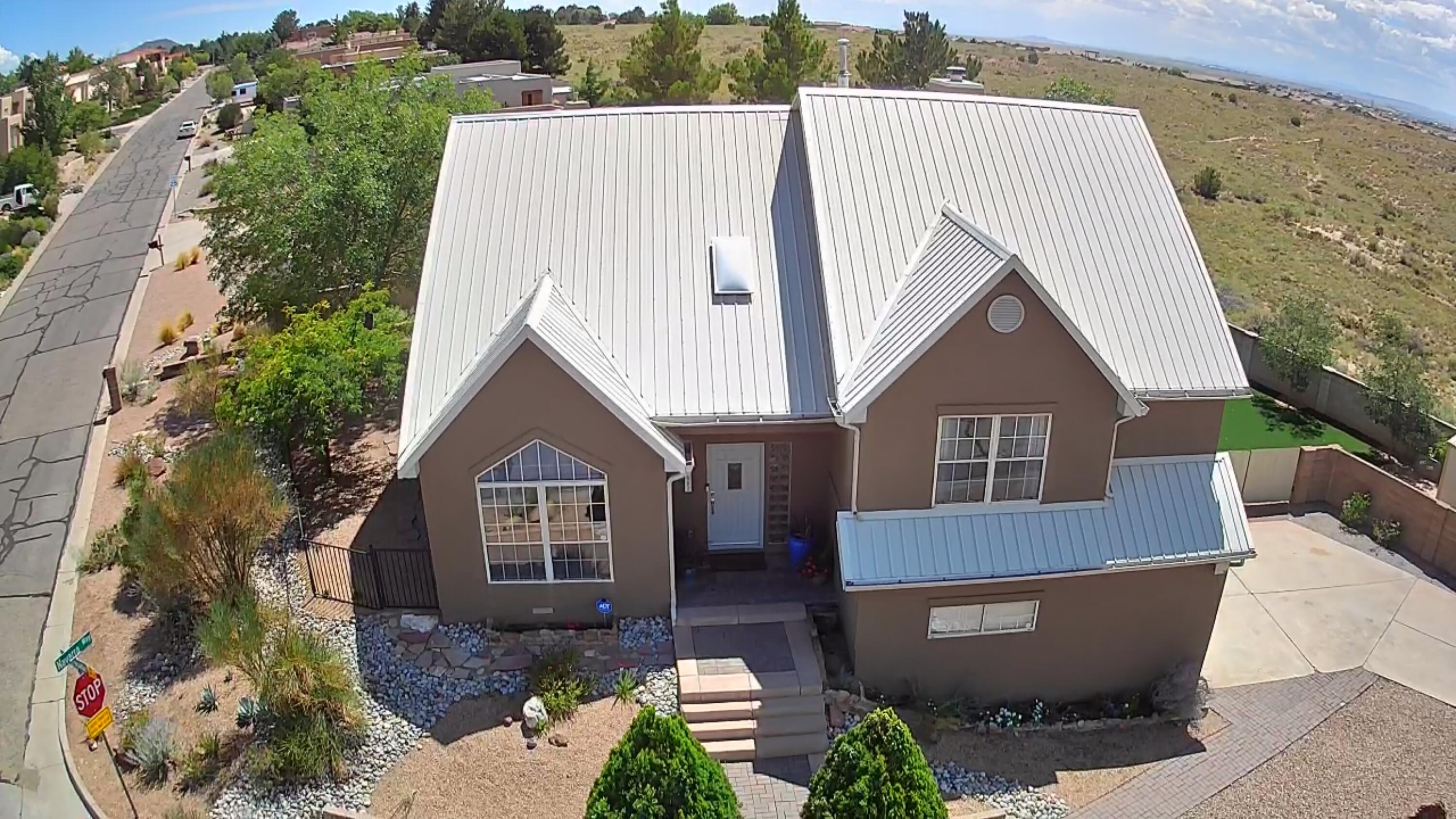 This gorgeous, one-of-a-kind custom home is nestled on a large corner lot overlooking 40 acres of open space, with stunning 360* mountain, city, and desert views. The quaint Four Hills neighborhood features both people and dog parks, hiking trails, and close-in city access. Inside, there is an open chef's kitchen with quartz counters, breakfast bar island, stainless appliances, plus soaring ceilings, hardwood floors, a cozy fireplace, and amazing walls of windows. The primary suite has a large soaking tub, separate shower, 2-way fireplace, and is adjacent a large, walk-in closet dressing room. Enjoy the spacious yard, new covered deck, recent stucco, roof updates, 4 Ring cameras, new shed, and washer/dryer. The downstairs bonus room can be a 4th bed, playroom, or media room.