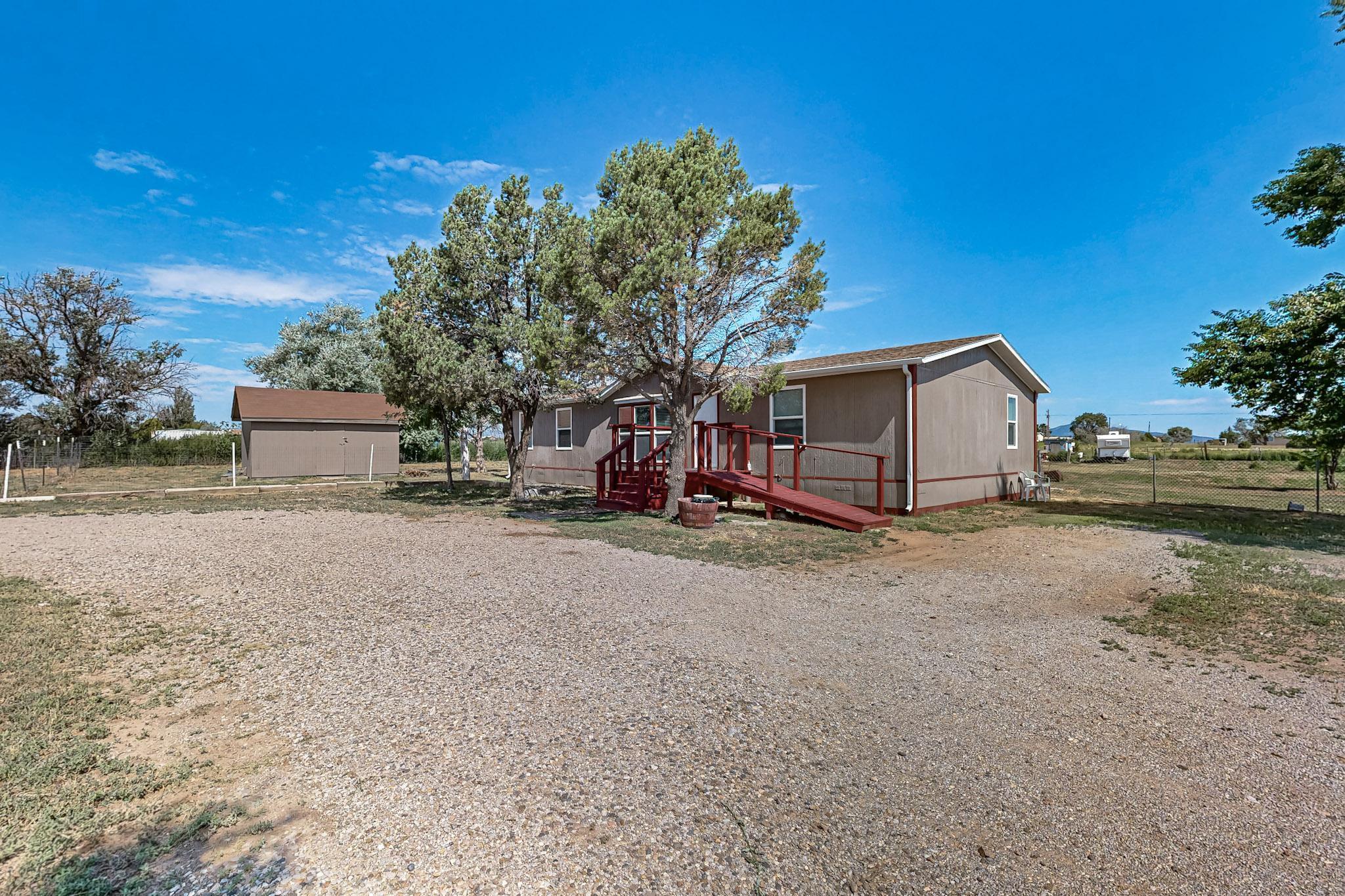 Fully remodeled home on a spacious 2.5-acre property. This beautiful residence features 3 bedrooms, 1 3/4 baths, and two living areas, one complete with a cozy fireplace. The kitchen flows into the dining area and includes a breakfast bar. The luxurious owner's suite offers double sinks, a walk-in shower, and ample storage, plus a large walk-in closet. Large laundry room even has a water softener system.  Enjoy the lovely views from the generous rear deck that has a gate for the goats! The property is fully fenced in the back and includes an additional front pen for pets. A circular drive provides convenient access and extra space for vehicles. Large storage shed for tools. This home is move-in ready.  Schedule your showing today!