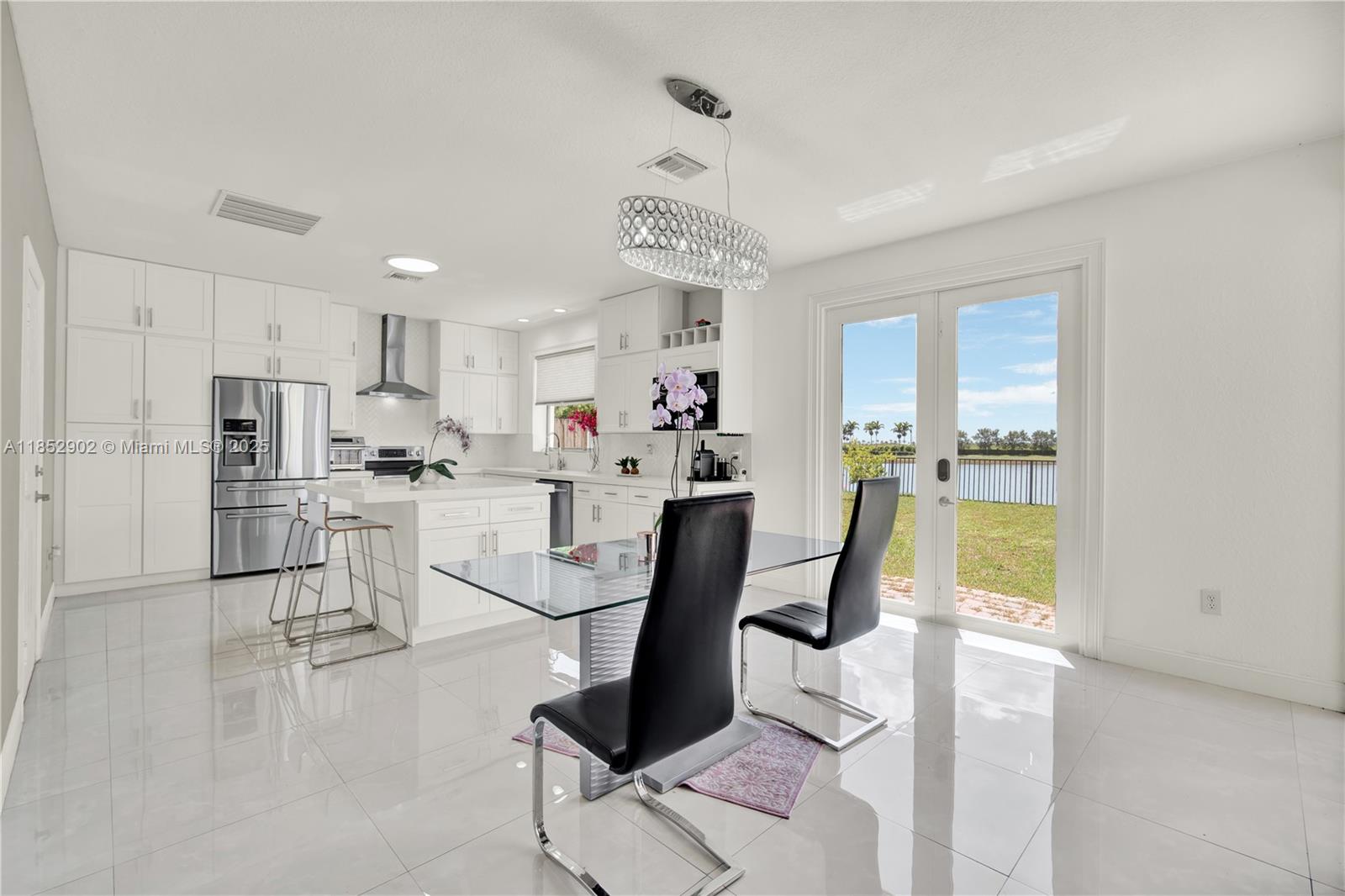 Your dream home + resort-style living! Beautifully updated 5BD/3BA Lake view home in Mallorca at The Vineyards. Includes a convenient downstairs bedroom with full bath. Custom (2023) kitchen w/quart countertops, wood cabinets Samsung appliances. Bamboo & porcelain tile floors. New AC (2020), accordion shutters, impact French door, Ring doorbell & 4 Eufy cameras. Extended driveway (4+ cars), garage fits 2 large cars. Puronics water purification (2025) w/ NASA tech & 25-yr warranty. This family-friendly community boasts an incredible clubhouse with gym, waterpark, pool & more! Unbeatable location: near Homestead Miami Speedway, highway, Florida Keys, & shops. Your perfect home awaits!