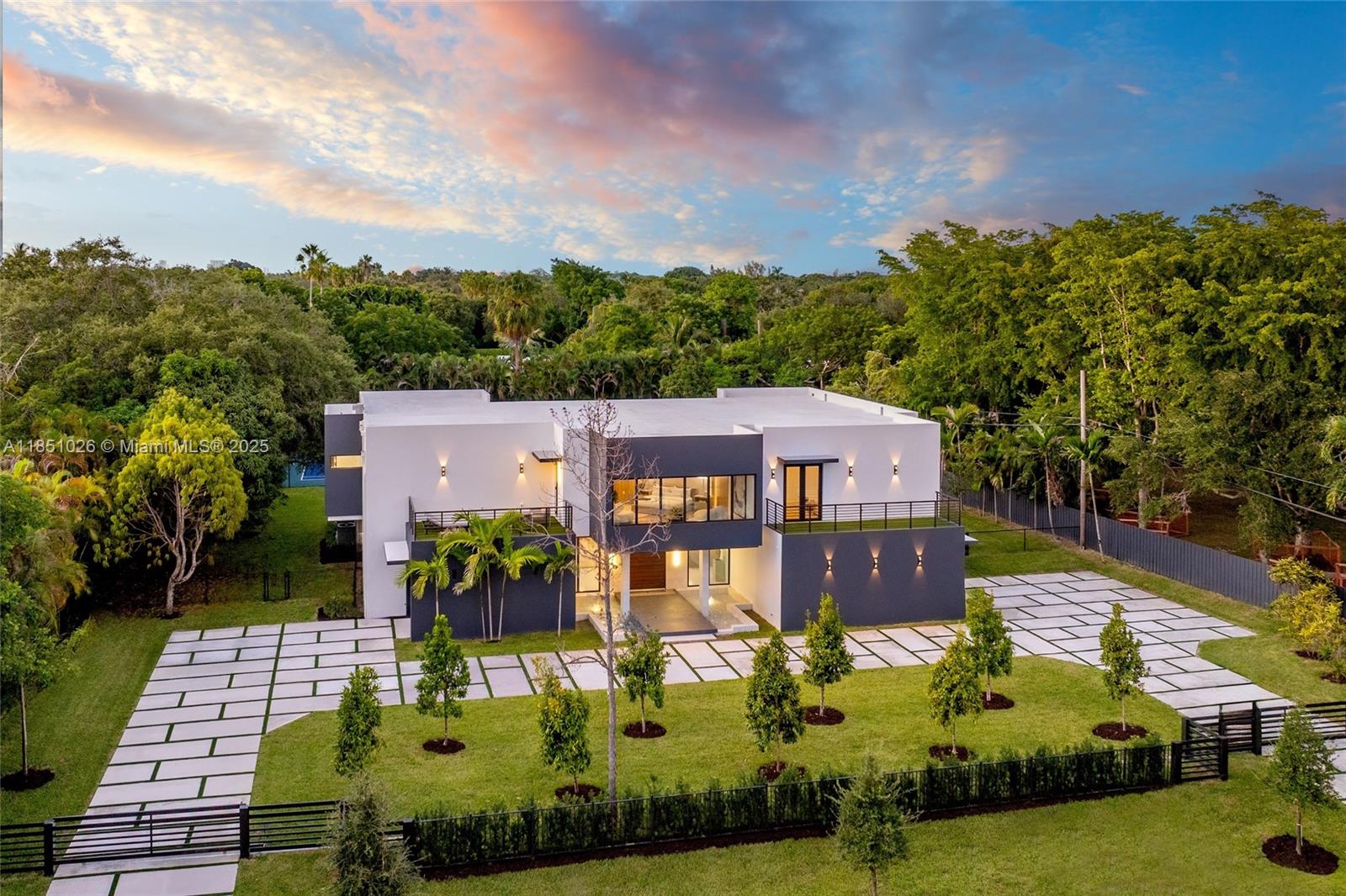 Welcome to a stunning new luxury home in the heart of Pinecrest. This expansive estate offers 8,673 sqft of living space with 7 beds and 7.5 baths in the main house, and a 1/1 guest house. Enter via a floating bridge flanked by water features, leading to elegant interiors with hardwood and tile floors, custom lighting, and a chef’s kitchen featuring premium appliances. The primary suite includes a custom walk-in closet, marble-clad bath, and a hidden safe room. A concealed media room adds flexible space for a theater, studio, or playroom. Additional features include a wine cellar area, elevator shaft, laundry room, and a private backyard with a pool, lighted tennis court, 3 balconies, and lush landscaping with fruit trees. This extraordinary home offers the ultimate in luxury and privacy.